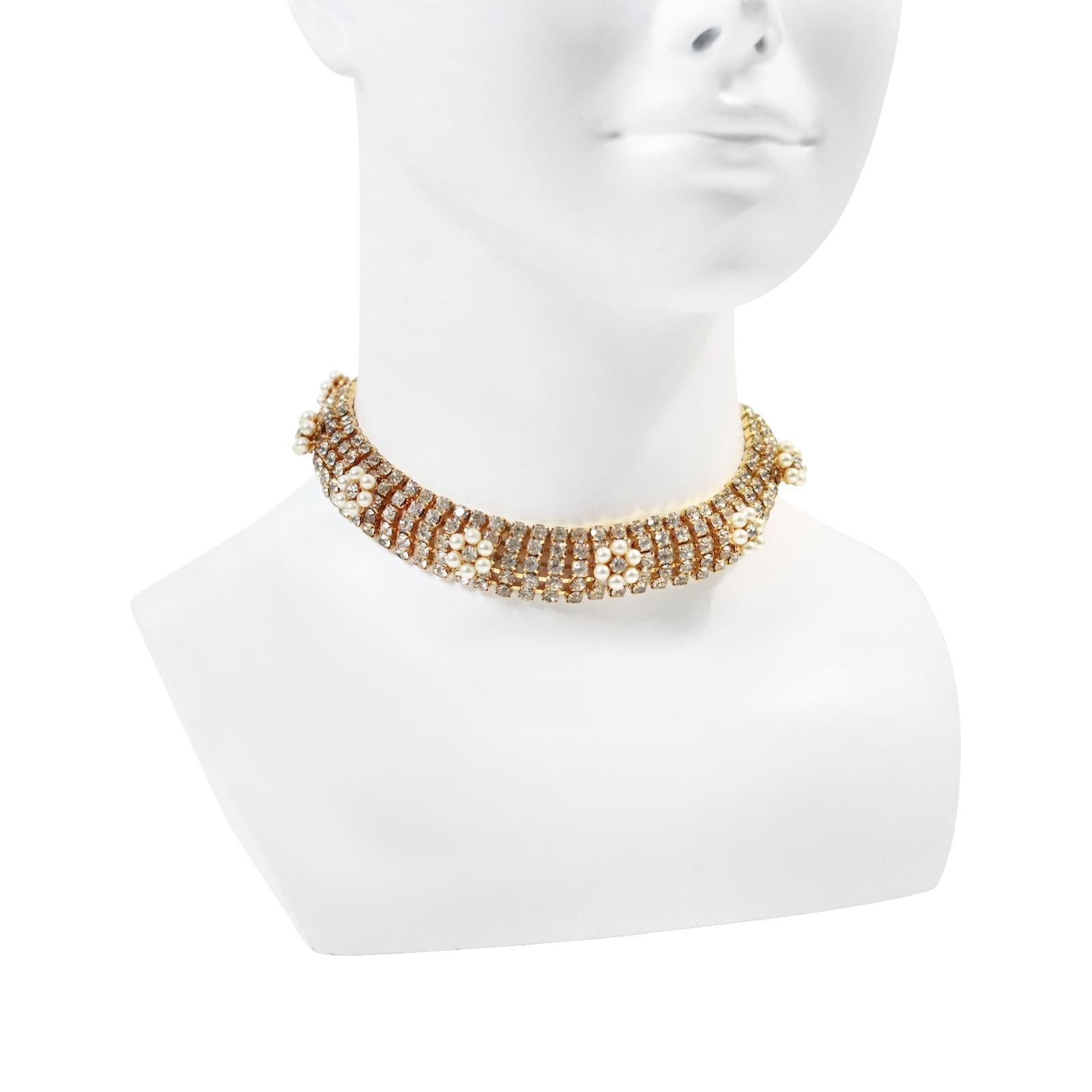 Vintage Diamante Gold Tone with Faux Pearl Mid Size Choker Circa 1970s. This is a 5 row choker with prong set round stones. Then on top are small round flowers or round pieces surrounded by faux pearls with a diamante in the middle.  Just