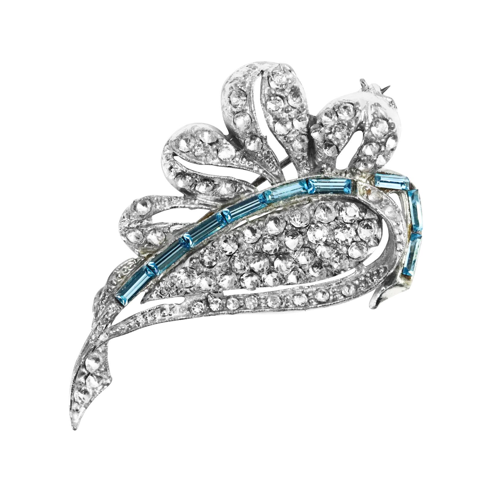 Vintage Diamante Leaf with Pave and Blue Baguette Brooch Circa 1960s. The brooch is made of  pave with a line of light blue baguettes running through it.  The offset of color makes the brooch. These brooches really are such a gorgeous representation