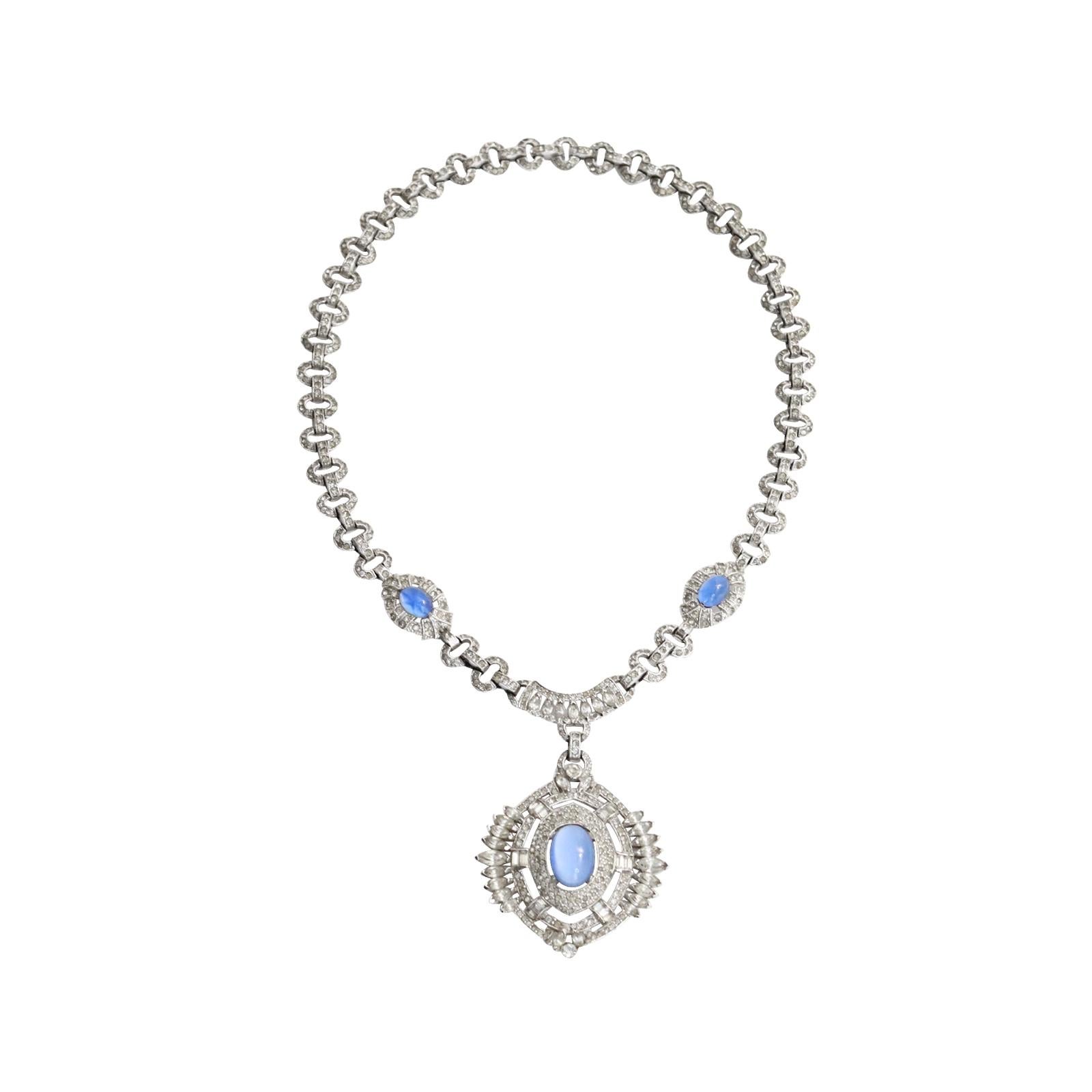 Vintage Diamante with Blue Shiny Cabochon Dangling Pendant Necklace Circa 1960s. This Gorgeous piece has al different cuts of stones including pave, and pear and then has three blue shiny cabochons that are in such perfect shape and truly look like