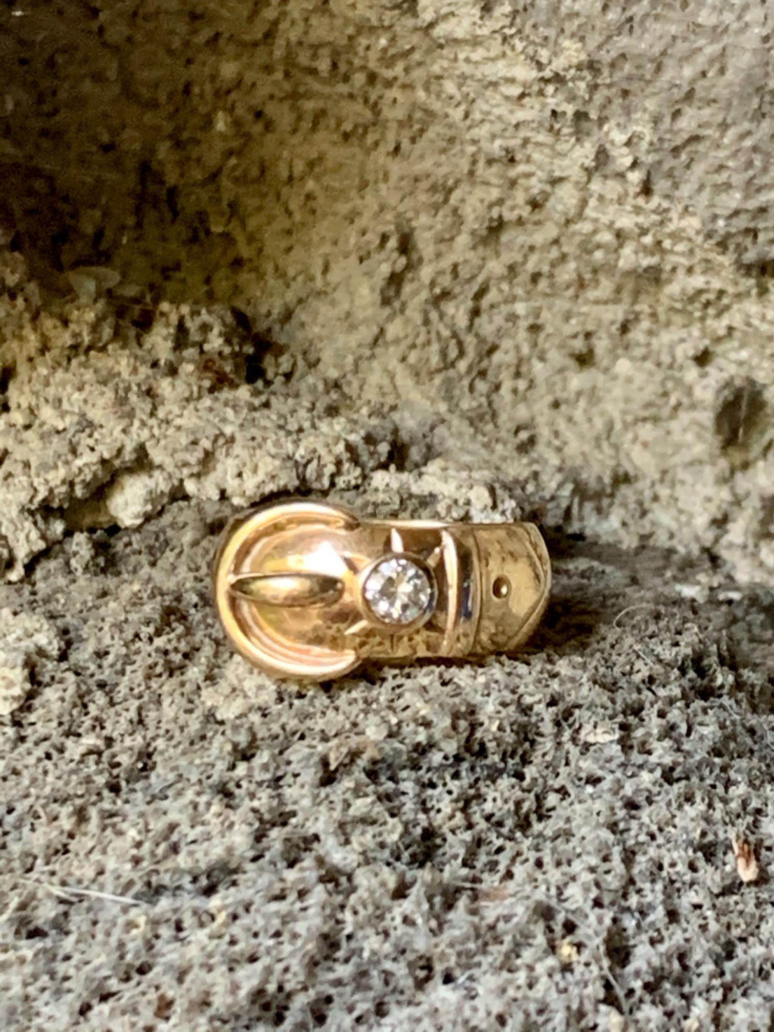 This buckle ring features a 20 point Diamond with color of G/H and clarity of VS(2).  The band measures 7.5mm wide.

Size 7 1/2
Weight: 8.0 grams