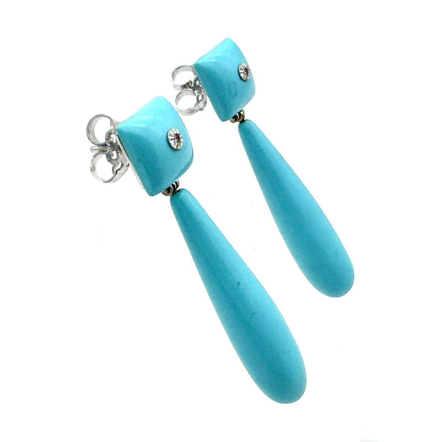 The drop earrings were created in the late 20th century. The turquoise is a turquoise composite formed into square elements that are mounted in 14K white gold. The square tops are fitted with stud fittings. The centre of the squares are set with