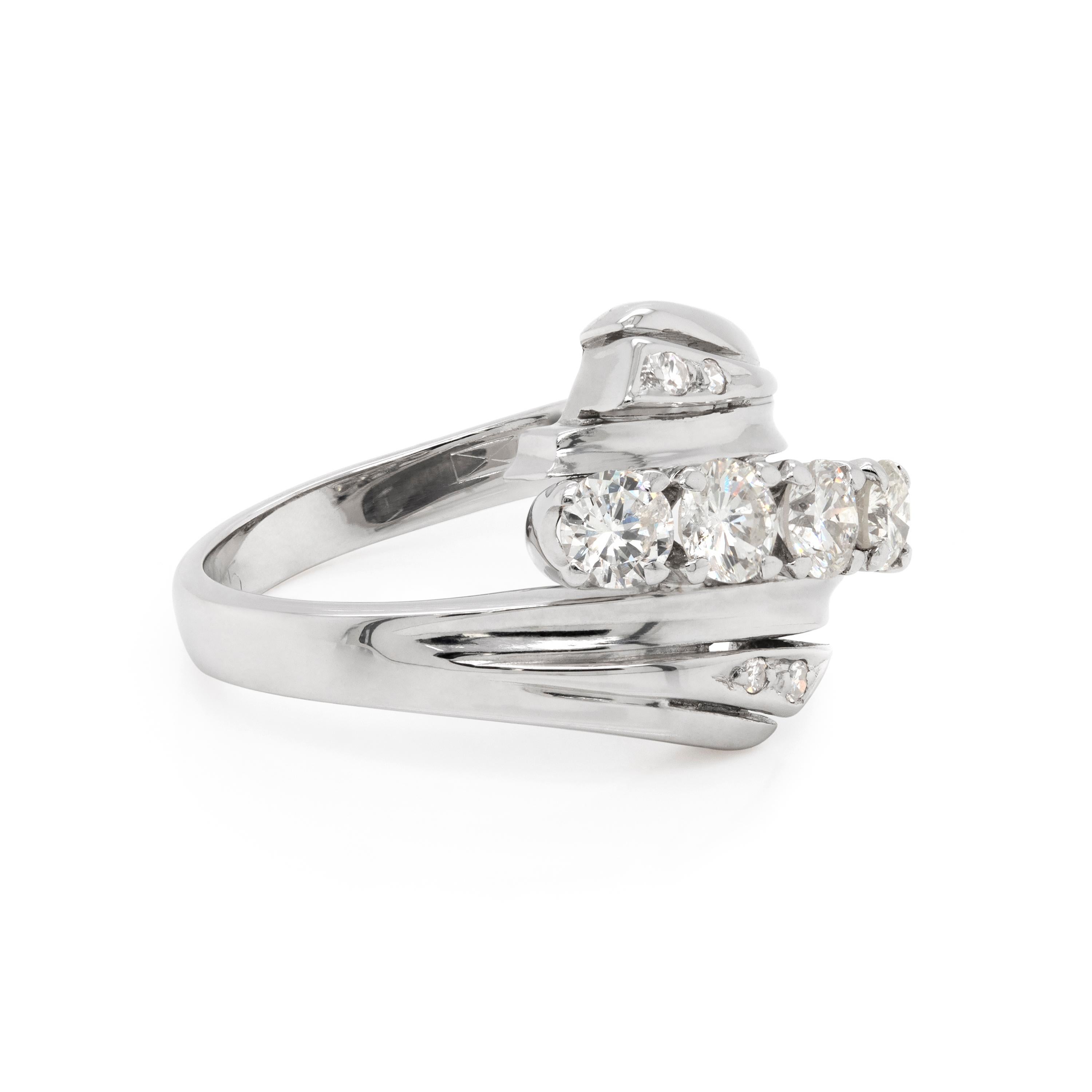 This beautiful 18 carat white gold crossover dress ring features four round brilliant cut diamonds weighing approximately 1.00ct in total, all mounted in claw, open back settings. The central stones are beautifully set within twisted shoulders, both