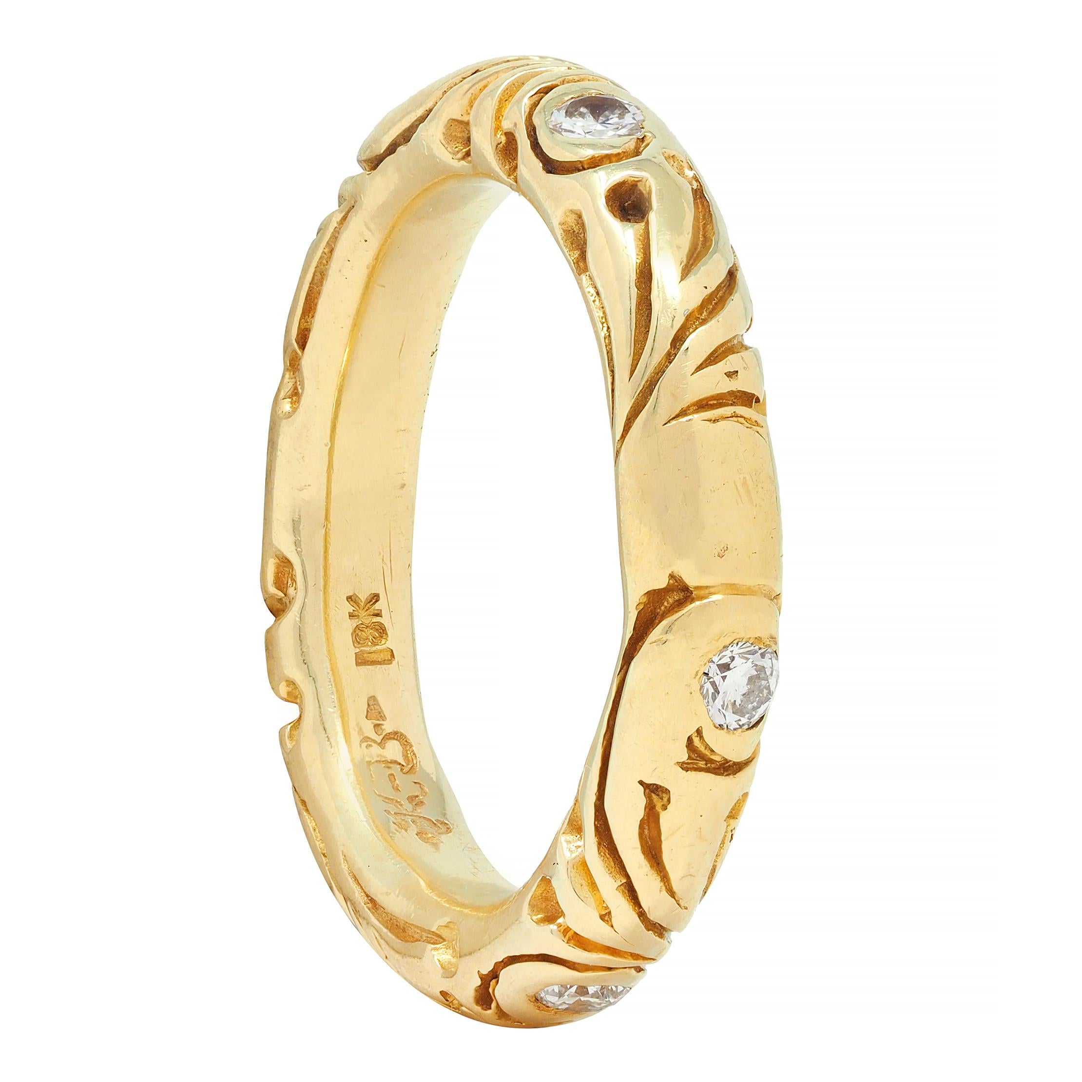 Designed as a rounded gold band 
With deeply grooved scroll motif fully around
Featuring flush set round brilliant cut diamonds 
Weighing approximately 0.36 carat total 
G/H color with VS2 clarity
With high polish finish 
Stamped for 18 karat gold