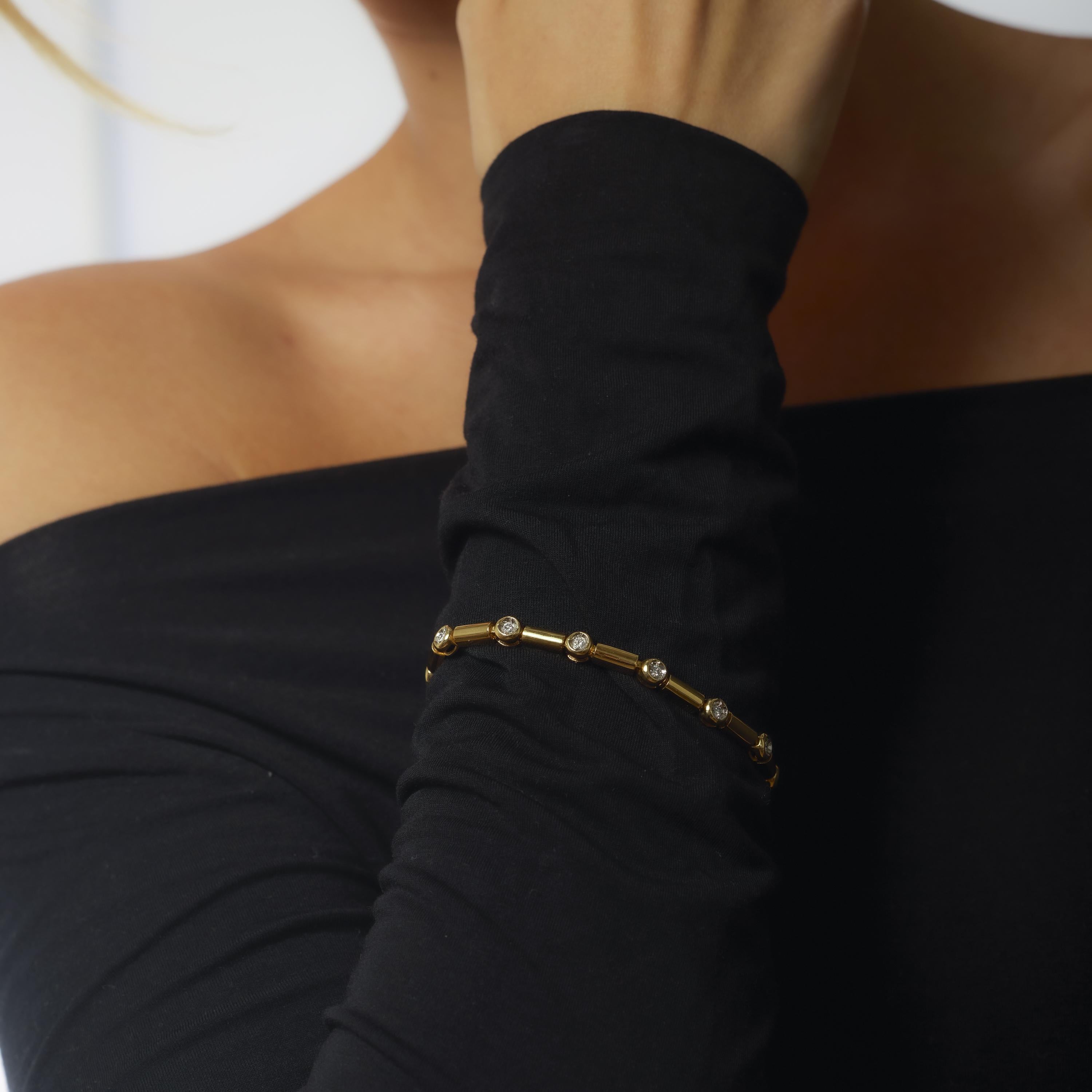 This vintage 18k yellow gold bracelet sparkles with thirteen bright round brilliant cut diamonds, totaling 1 carat in crisp F-G color and VS clarity. Crafted in the 1990s, it offers timeless sophistication and effortless luxury.