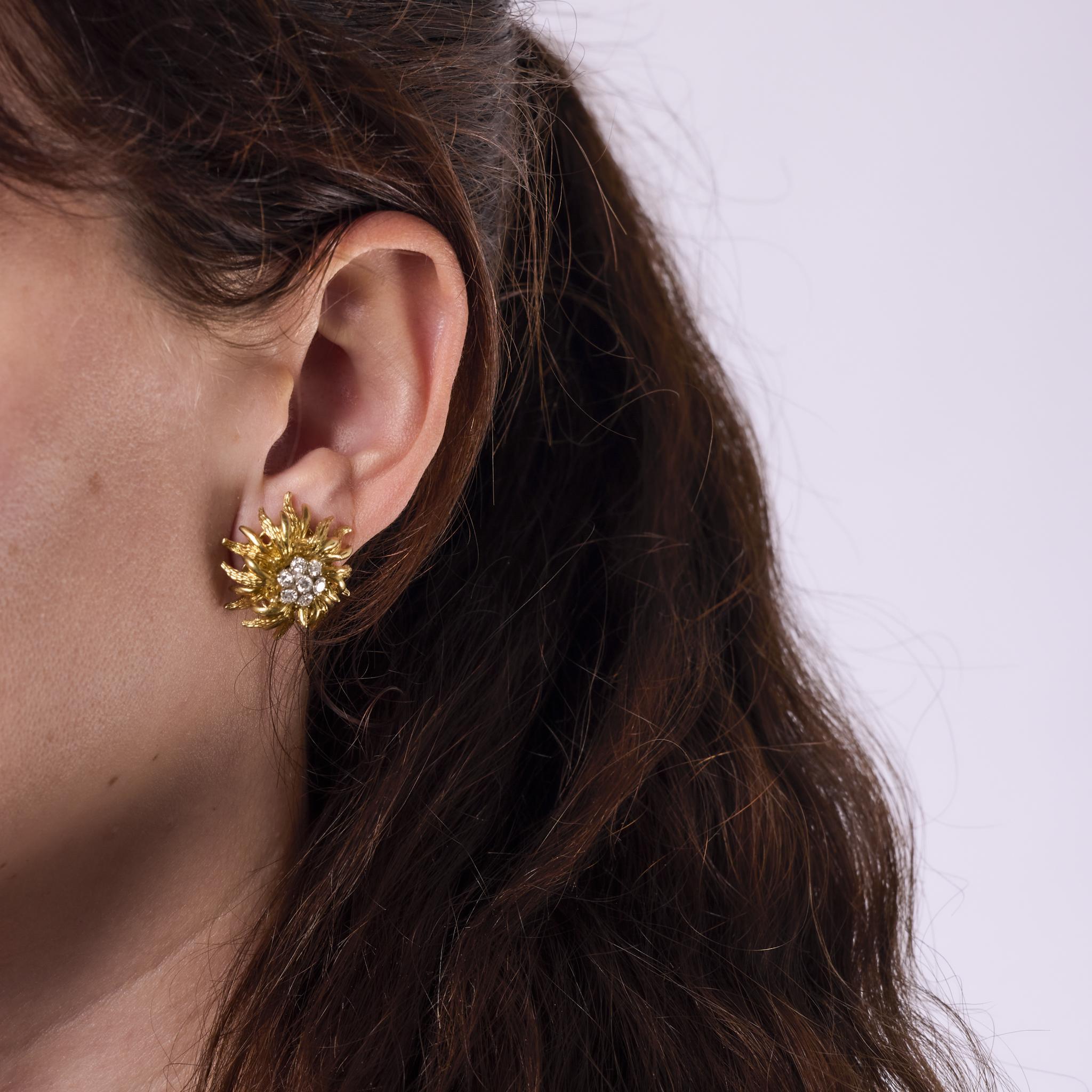 Questi orecchini a clip a fiore vintage degli anni '70 sono realizzati in oro giallo 18 carati e incastonati con 14 diamanti rotondi taglio brillante per un totale di circa 0,75 carati. I diamanti hanno una gradazione di colore E-F e una purezza VS,