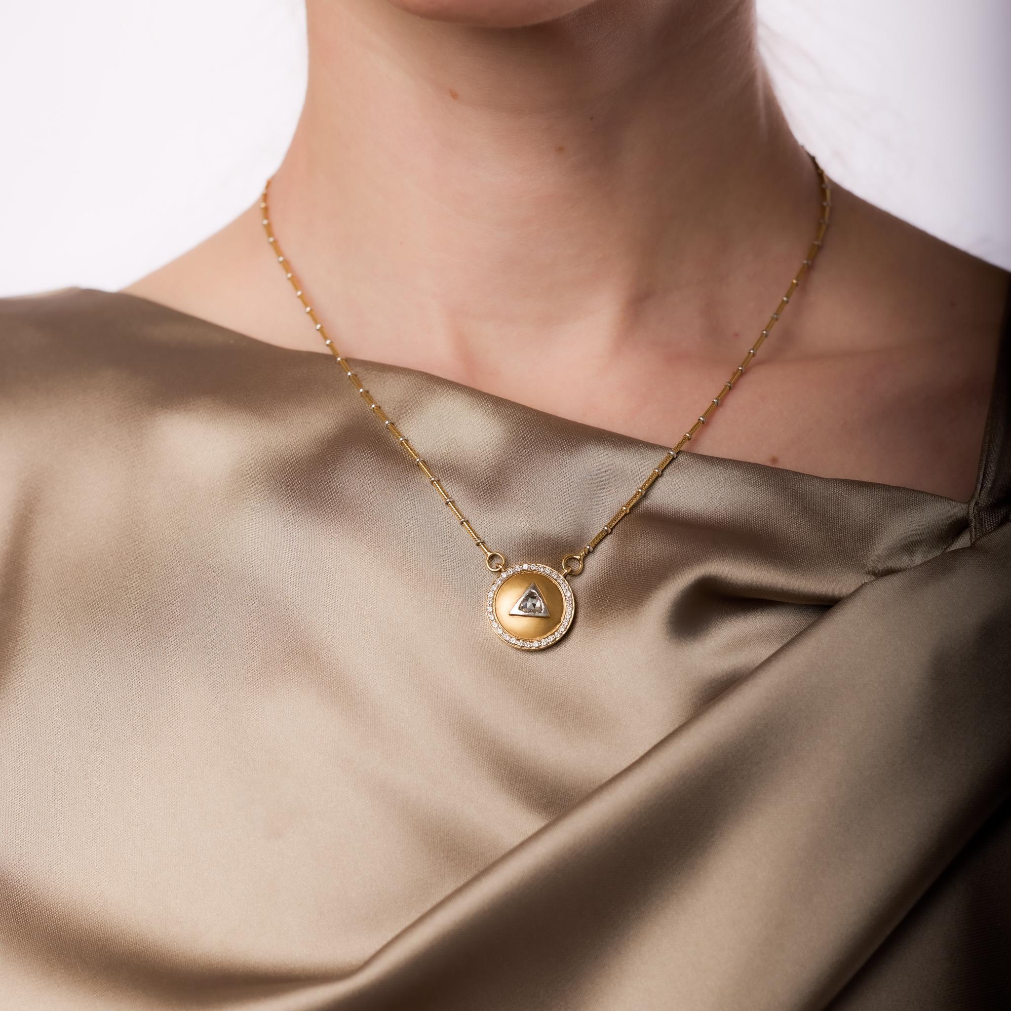 This vintage 18k yellow gold pendant necklace features a 0.27-carat rose cut diamond, H-I color, VS clarity, accented by 32 round brilliant cut diamonds totaling approximately 0.30 carats, E-F color, VS clarity. Platinum bead detailing adds a