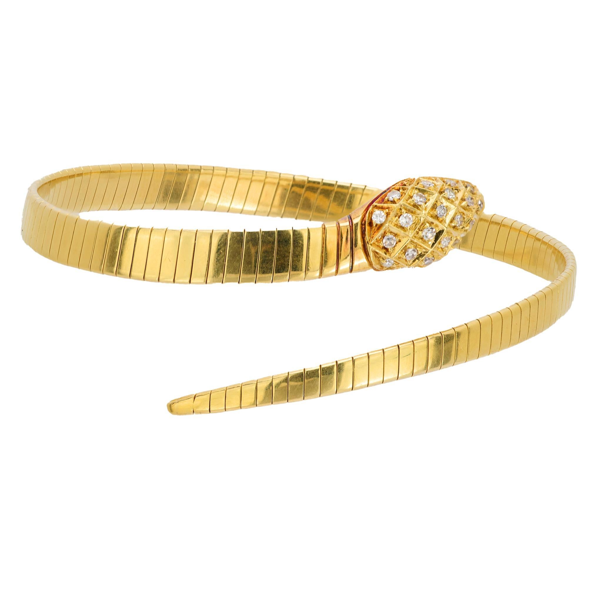 This vintage 18k yellow gold tubogas snake bangle showcases 25 single cut diamonds totaling approximately .25 carats, E-F color, and VS clarity. Crafted in the 1970s, it is hallmarked with a purity mark, measures 7½ inches, and weighs 23.20 grams.