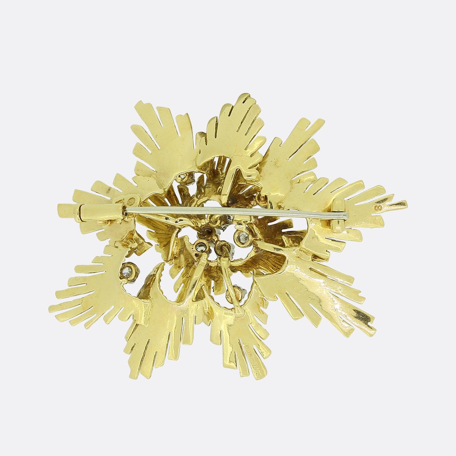 This is a vintage 18ct yellow gold diamond brooch. It features a lovely textured design with diamonds set sporadically around the 3D gold model. The brooch is crafted in a typical 1980s style but it has an import hallmark which appears to be dated