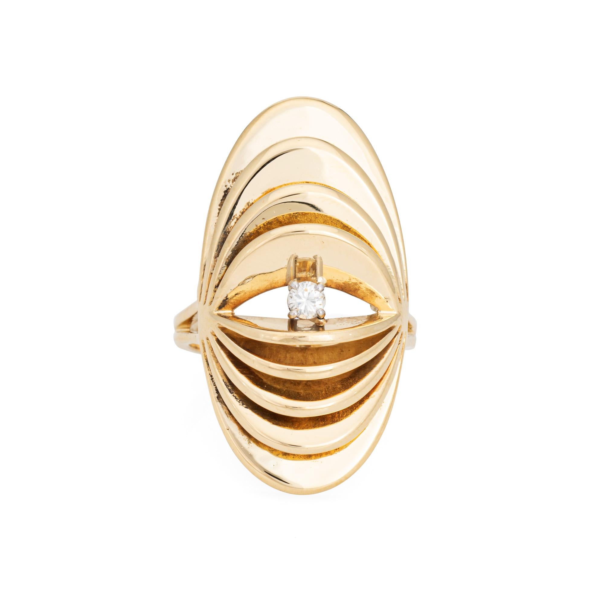 Stylish vintage diamond accordion ring crafted in 10 karat yellow gold (circa 1970s to 1980s). 

One round brilliant cut diamond is estimated at 0.10 carats (estimated at H-I color and VS2-SI1 clarity).

The striking cocktail ring highlights a long