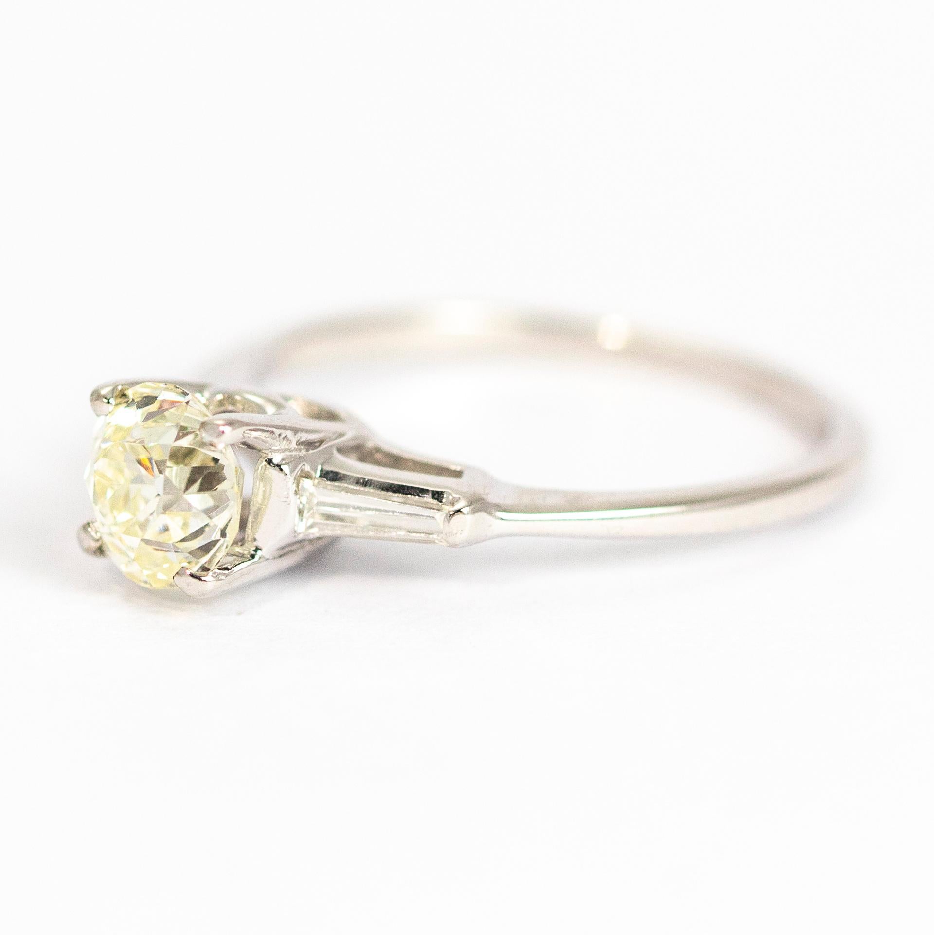 A sparkling 1carat diamond sits proud on the top of this 14ct white gold beauty. The centre diamond sits on top of a simple open work setting. Either side of the centre stone are two tapered baguettes which finish the ring off perfectly.

Ring Size: