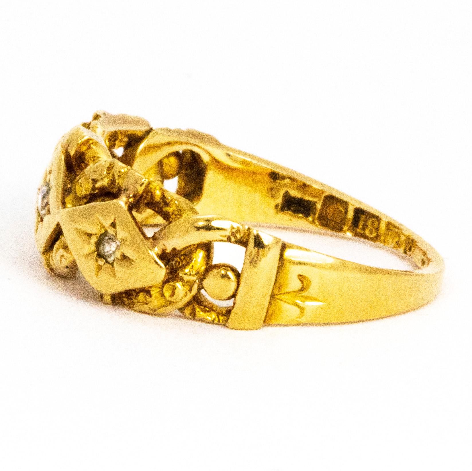 This highly decorative gypsy ring features interlocking chain detail. The glossy 18ct gold holds three diamonds in star settings on smooth gold panelling whilst the chain detail is woven around it. The centre diamond in this ring measures