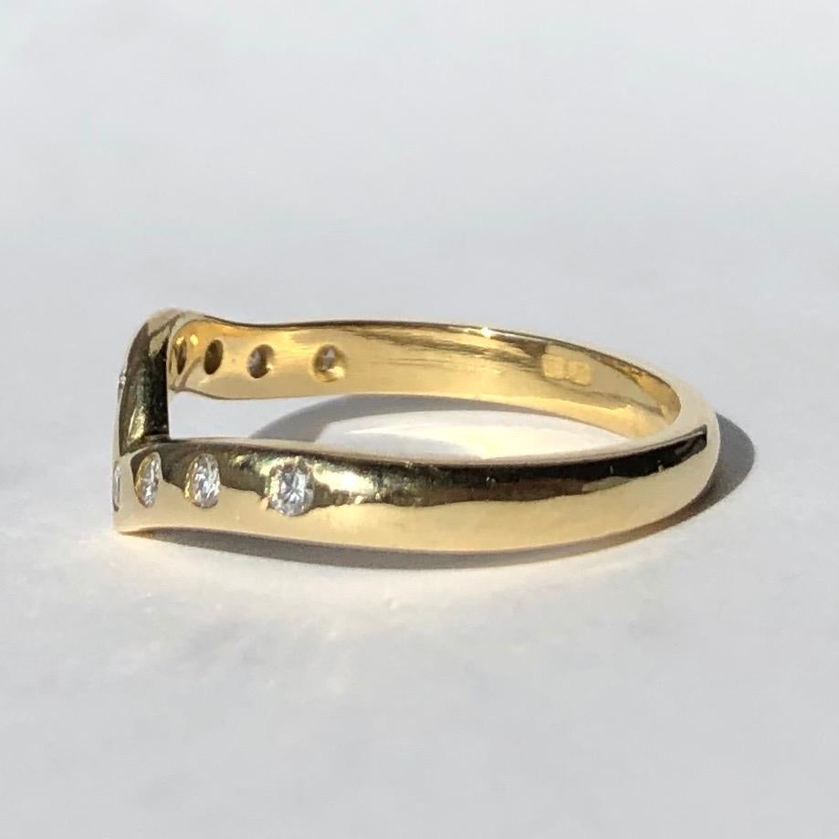 Nine stunning bright white diamonds sit within this 18ct gold band. The stones each measure a gorgeous 2pts and the band is modelled in the shape of a 'V' shape to it where the diamonds are set. 

Ring Size: K or 5 1/4
Band Width: 2mm 

Weight: 2.8g