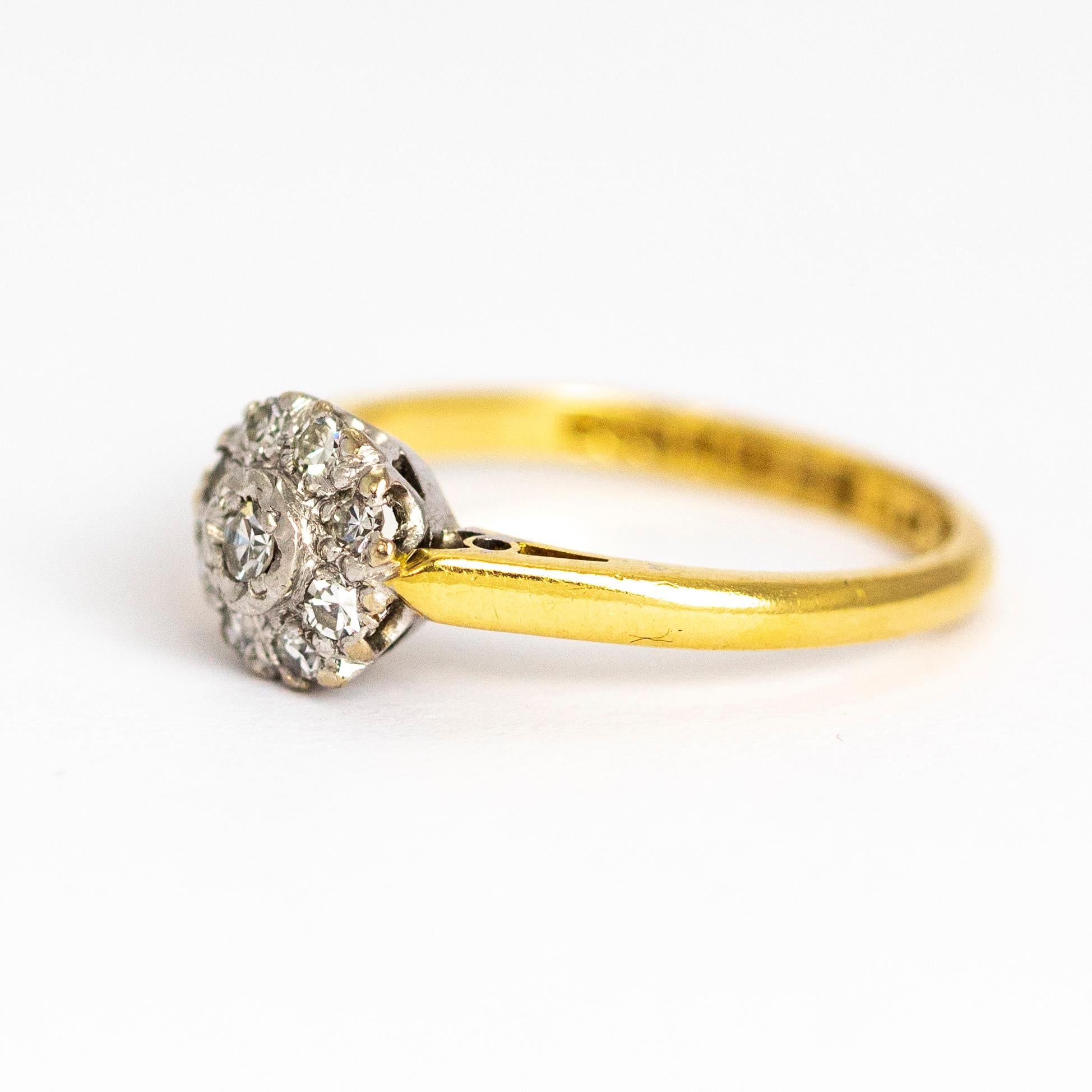 This ring has such a sparkle to it! The cluster holds a central diamond and eight smaller diamonds around it. The ring is modelled out of 18 carat gold and the diamonds are set in platinum. Made in Birmingham, England.

Ring Size: M or 6 1/4