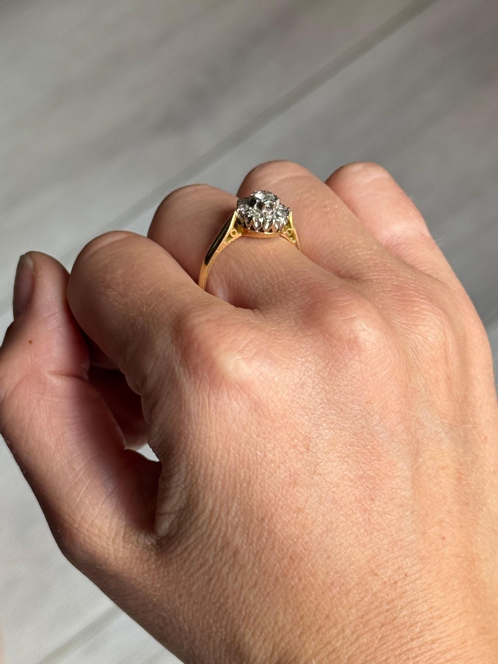 This ring is modelled in 18 carat gold and the diamonds are set in platinum. The diamond weight of this ring is 44pts. Hallmarked Birmingham 1973.

Ring Size: Q or 8 1/4 
Cluster Diameter: 10mm
Height off finger: 7mm

Weight: 3.8g