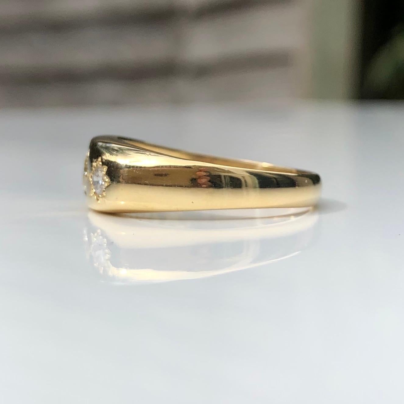 This gypsy ring holds three diamonds totalling approx 50pts and these are set in star settings. The glossy gold band is modelled in 18ct gold.

Ring Size: T or 9 1/2
Band Width: 6.5mm

Weight: 6.6g