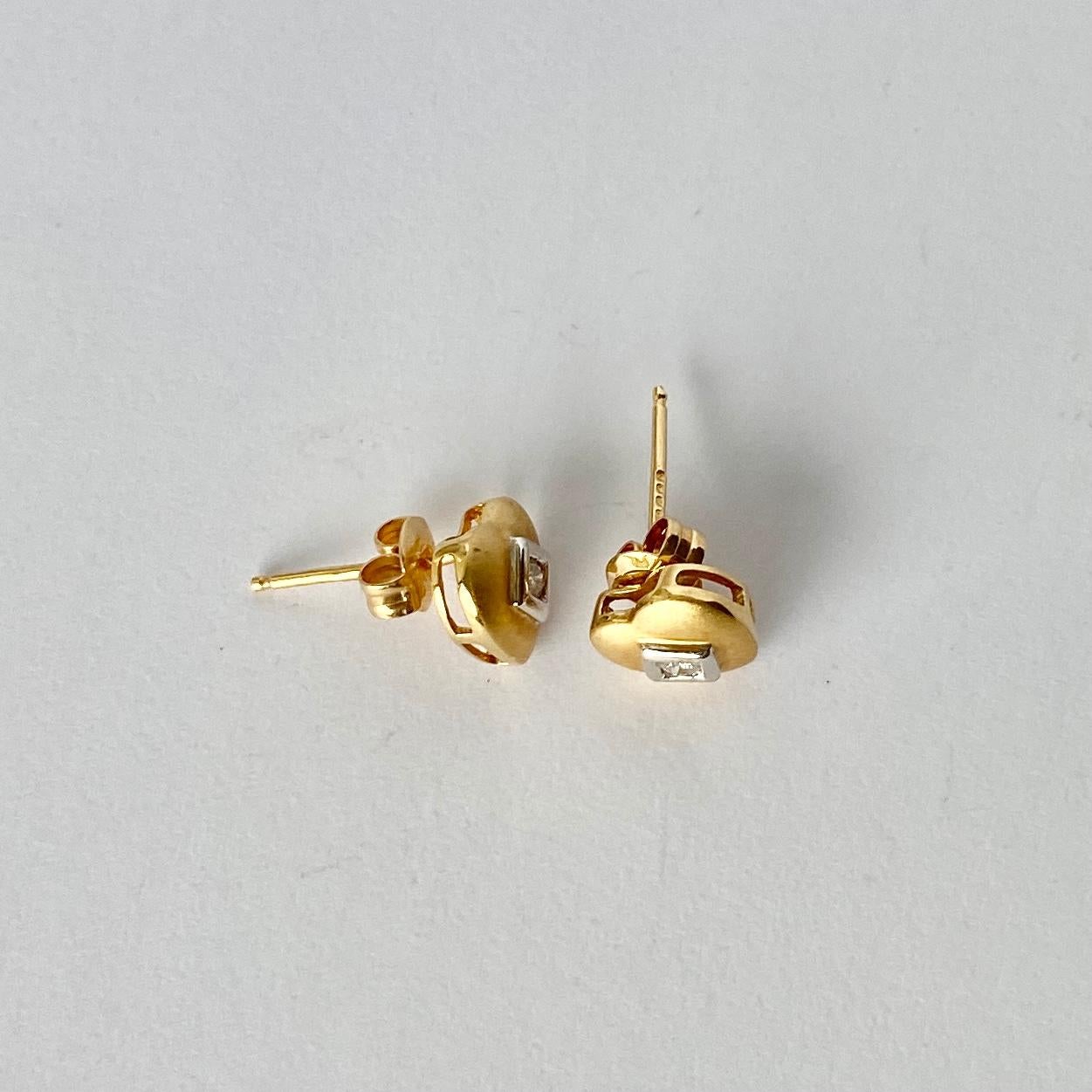 These gorgeous earrings are modelled in matte 18carat gold and each hold a sparkling diamond measuring 5pts each. The stones are set in white gold square settings. 

Dimensions: 8x8mm 

Weight: 1.9g