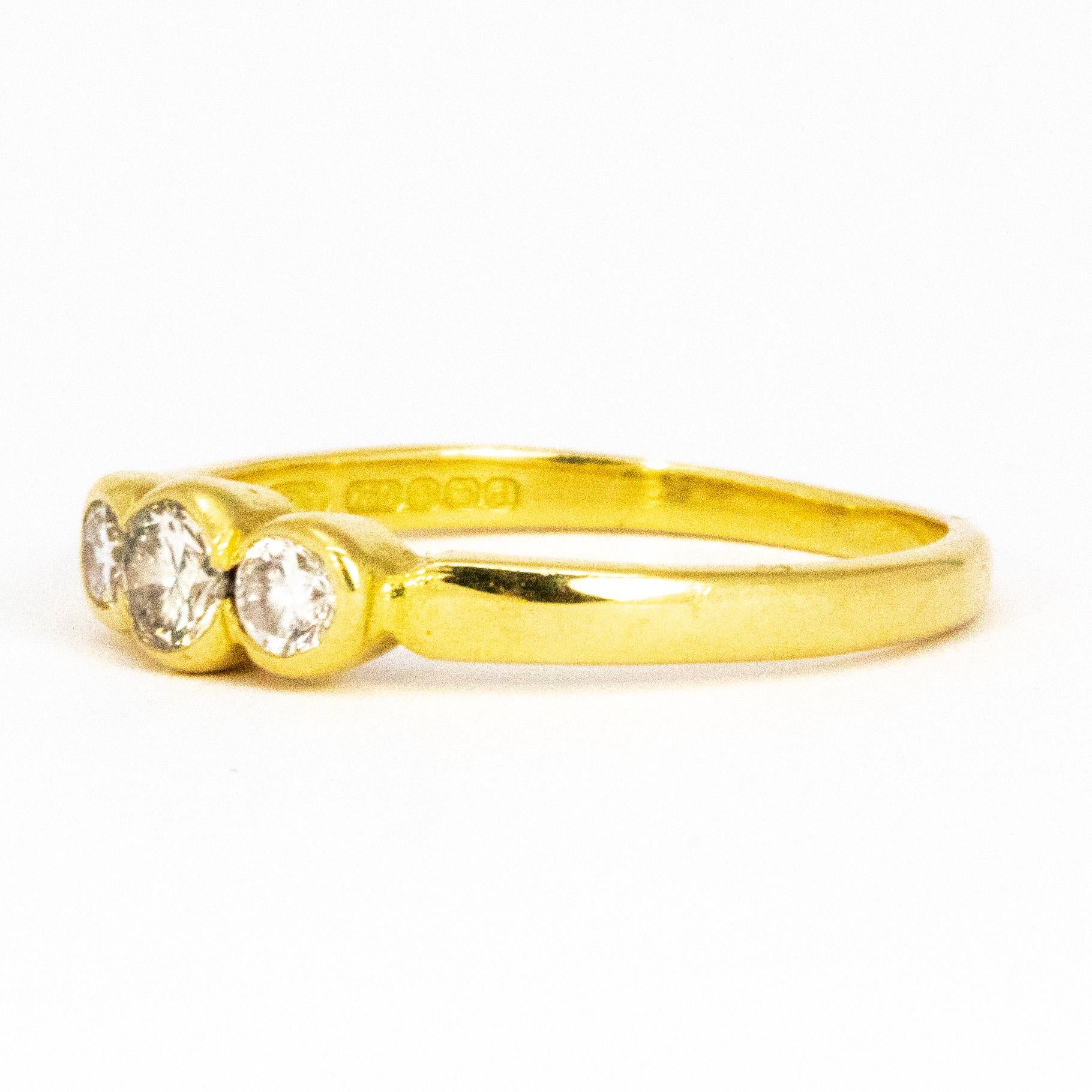 Sitting at the centre of this simple and fluid style gold band are three diamonds measuring 20pts at the centre and 10pts either side. The diamonds are brilliant cut and have a wonderful bright sparkle. 

Ring Size: N or 6 3/4