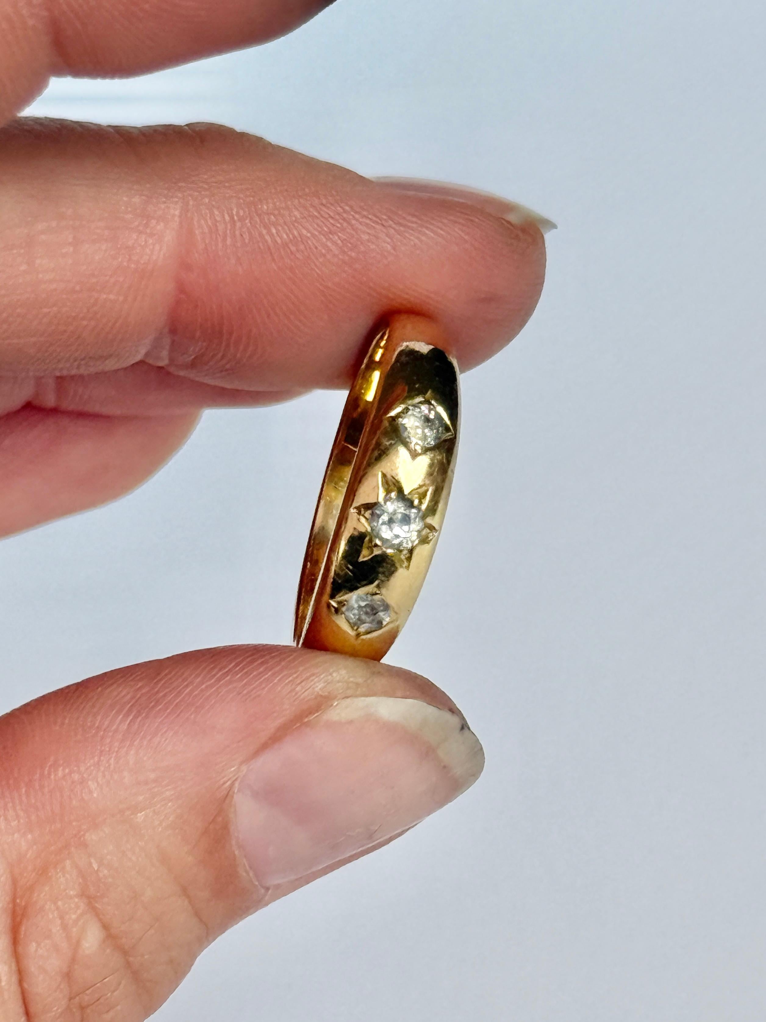 This gorgeous 18ct gold band holds three old mine cut diamonds totalling 24pts with the central stone measuring 10pts. They are bright and have a lovely sparkle and are set in star and diamond shaped settings. 

Ring Size: S or 9
Band Width: 6mm