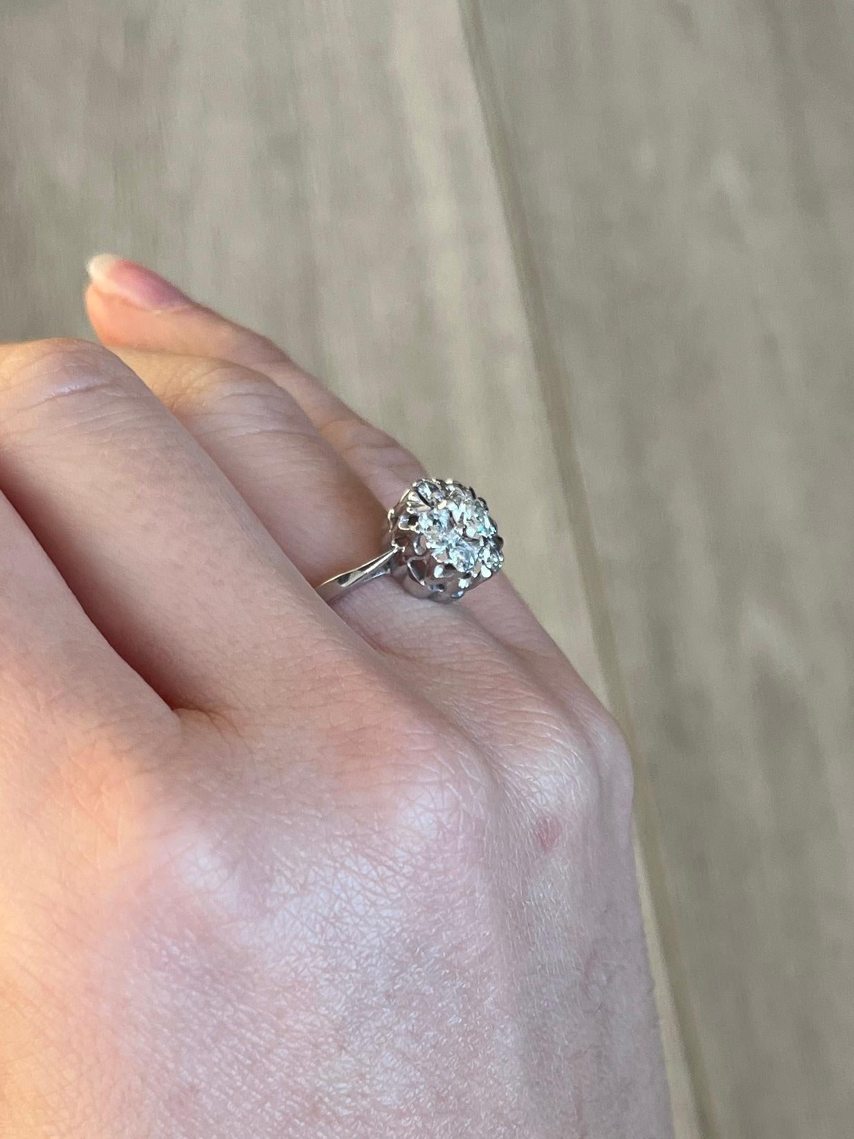 This cluster ring holds Diamonds totalling approx 78pts and are bright and sparkly. The ring is modelled in 18carat white gold. Hallmarked London 1975.

Ring Size: M or 6 1/4
Cluster Diameter: 11mm
Height From Finger: 7mm

Weight: 3.4g