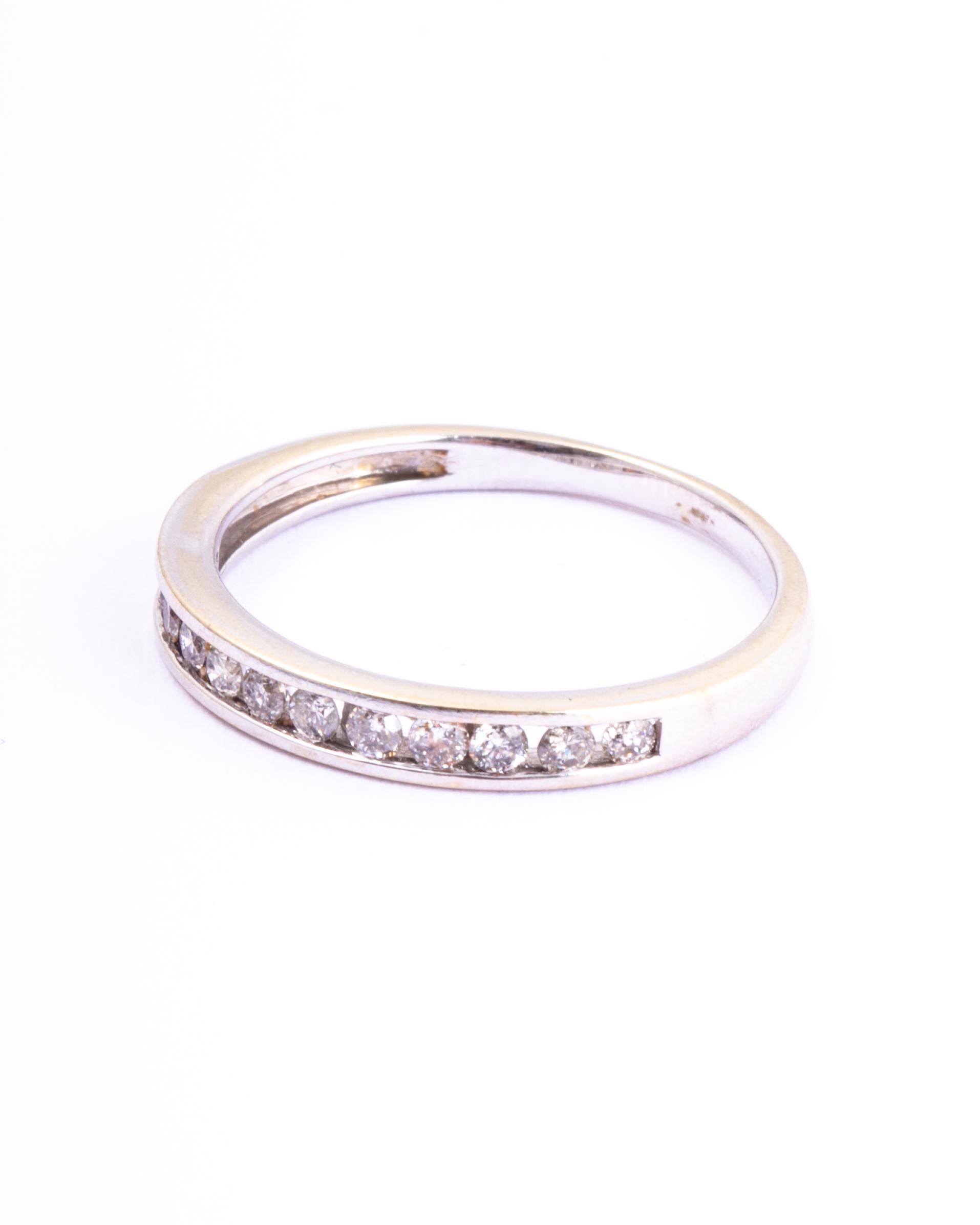 This half eternity band holds 25points worth of shimmering diamonds. The stones are set within the smooth 18ct white gold band. 

Ring Size: L or 5 3/4
Band Width: 2mm 

Weight: 1.9g