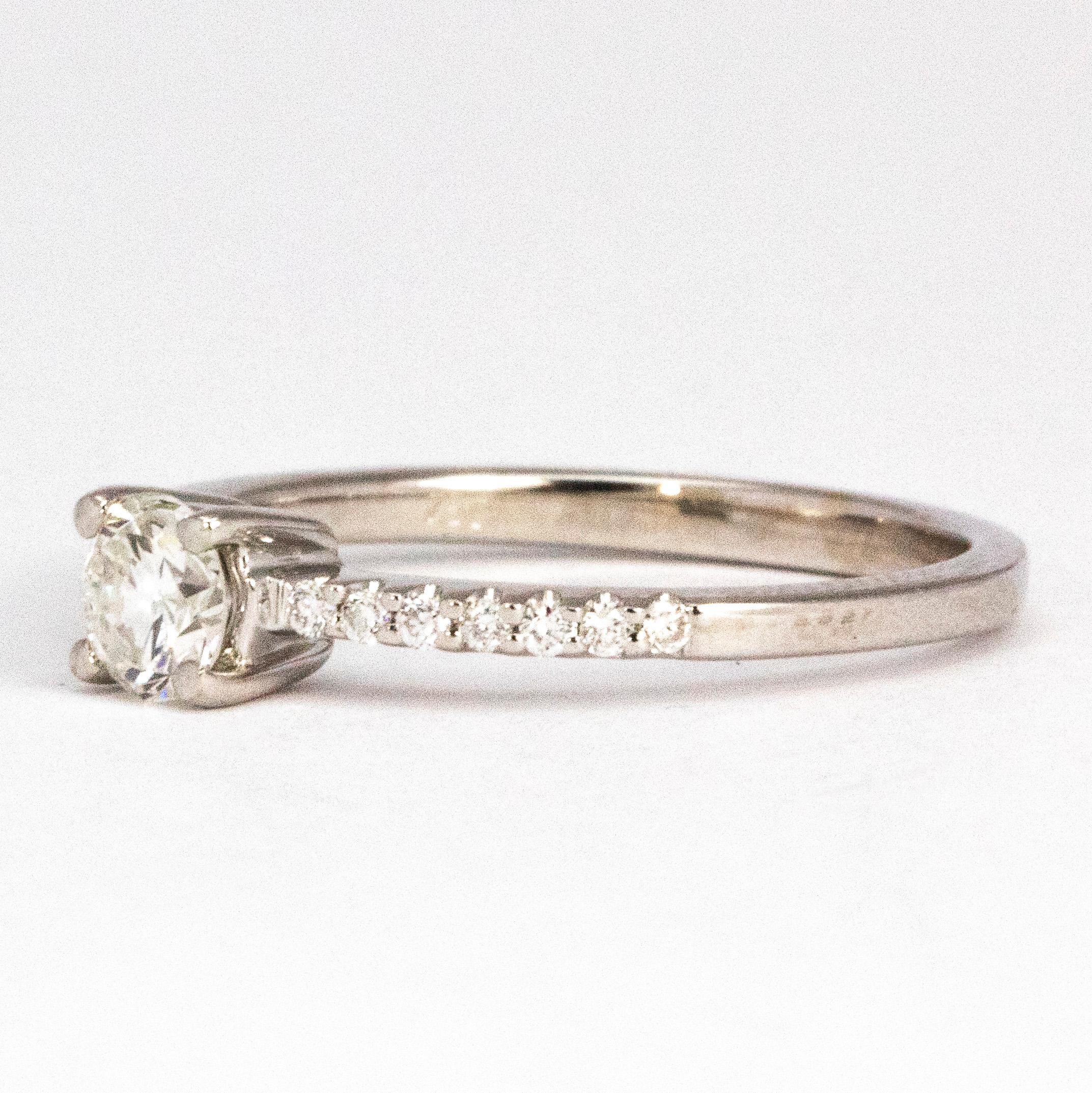This simple solitaire ring has a central brilliant cut diamond measuring 35cts. The shoulders have diamonds running through on to the band. The diamonds on the shoulders each and sit in delicate settings on the band. 

Ring Size: L 1/2 or 6
