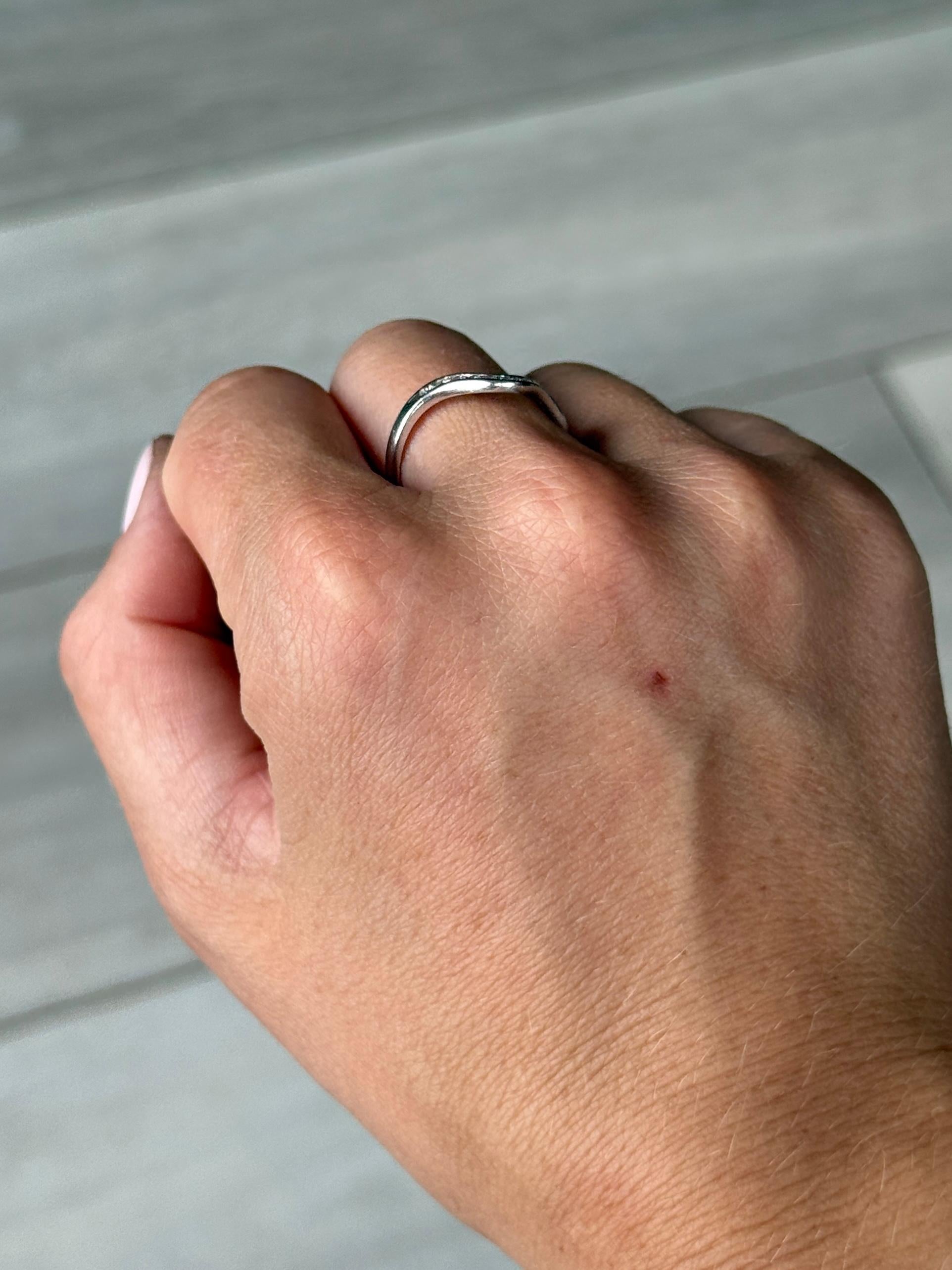 Eleven small yet glistening diamonds sit within this 18ct white gold band. The stones each measure 2pts and the band has a 'V' shape to it where the diamonds are set. This would allow the band to sit round. classic engagement ring or would make a