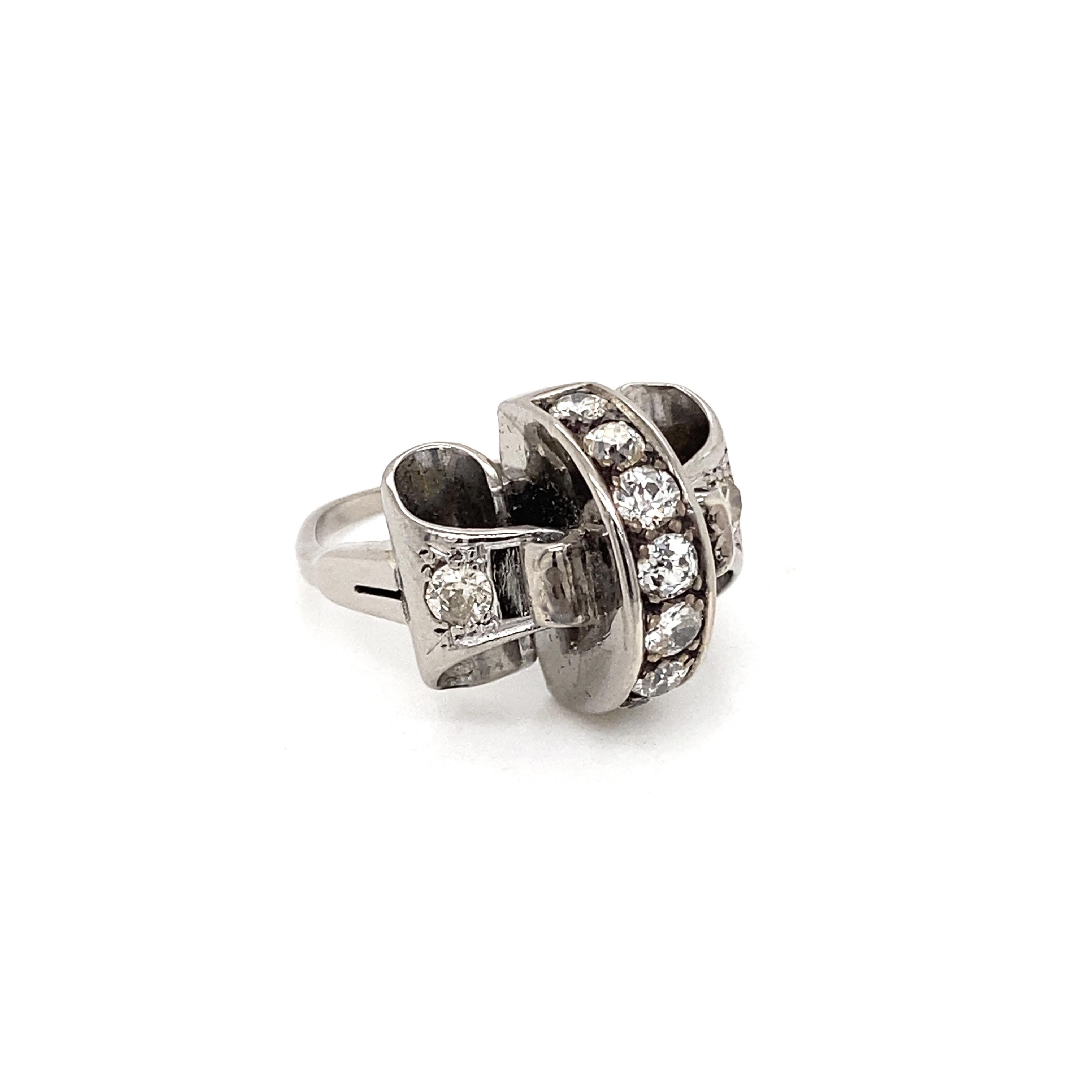 Step back in time and add a personal touch to any attire with this intricately designed diamond and platinum fancy cocktail ring.

Centring this special ring are 6 diamonds (a mix of four old cut and two round brilliant cut) mounted on a vertical