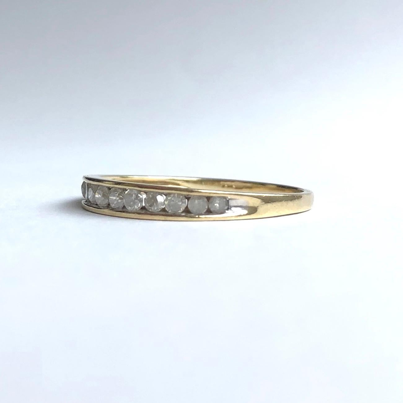 In this simple half eternity band sit 12 diamonds in a row which slightly graduate in size with the largest in the middle and the smallest on the outside. Modelled in 9ct gold. 

Ring Size: N 1/2 or 7
Band Width: 2mm 

Weight: 1.08g