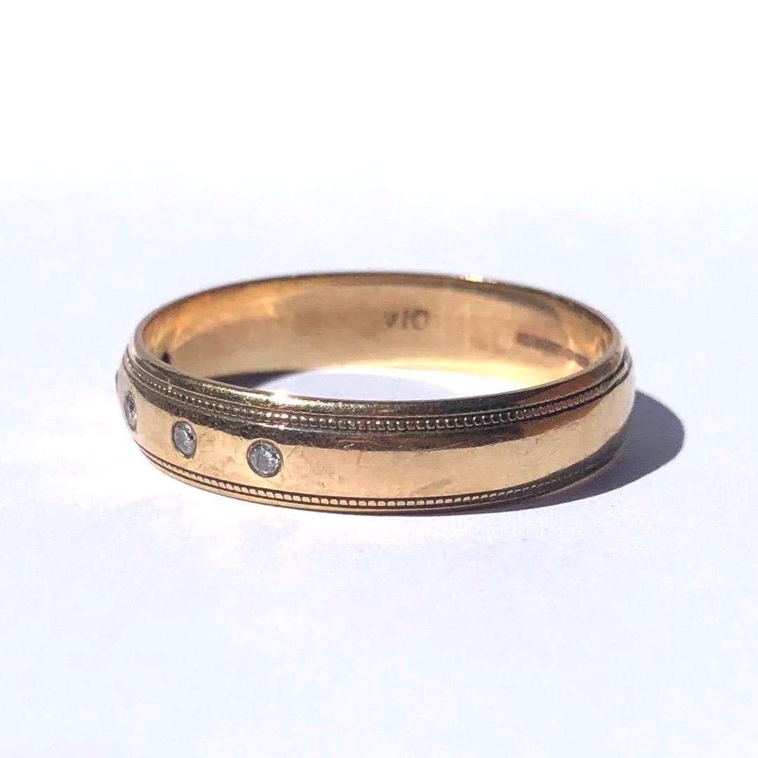 This 9ct gold band has two Iines of beaded detail on the outer edges and in between these there is a delicate line of five diamonds. The diamonds measure 3pts each. Made in Birmingham, England. 

Ring Size: W 1/4 or 11 1/4
Band Width: 4.5mm