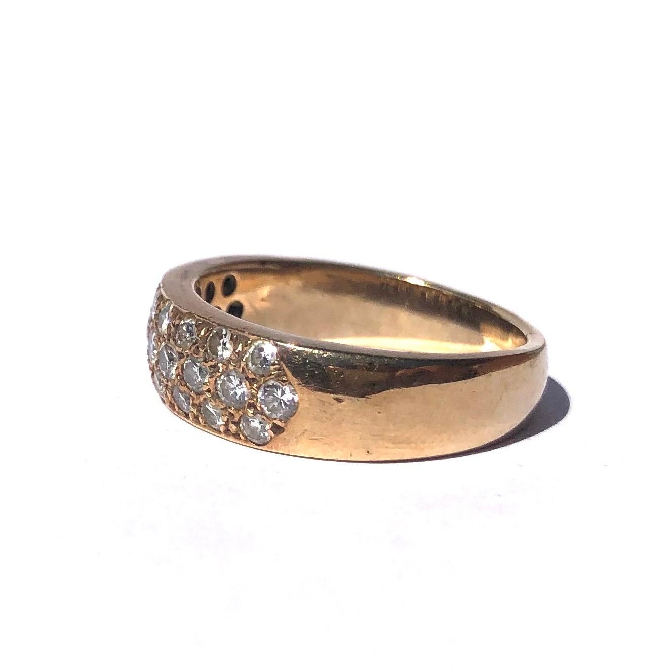 This gorgeous 9ct gold band holds three rows of diamonds. The middle row of diamonds measure 7pts each and the rows either side measure 5pts each. The sparkle is wonderful!

Ring Size: P or 7 3/4 
Band Width: 6.5mm 

Weight: 6.1g