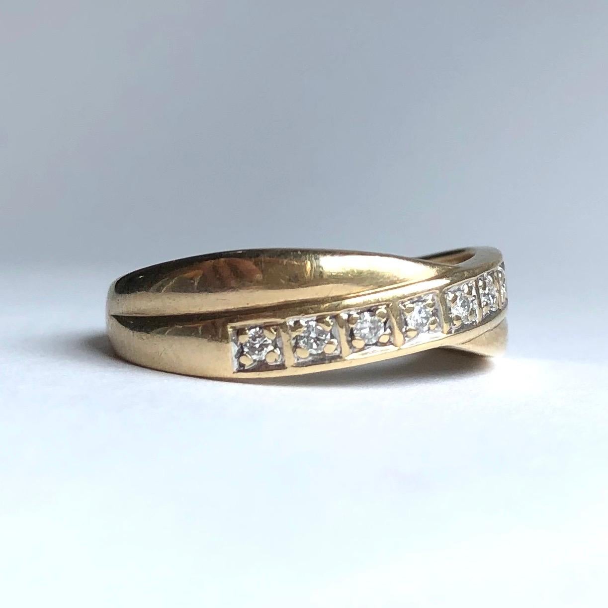 Set within one of the 9carat gold bands which twist around one another there are nine round cut diamonds which total approximately 30pts and are set in square shaped settings. 

Ring Size: N 1/2 or 7
Band Width: 6mm 

Weight: 2.1g
