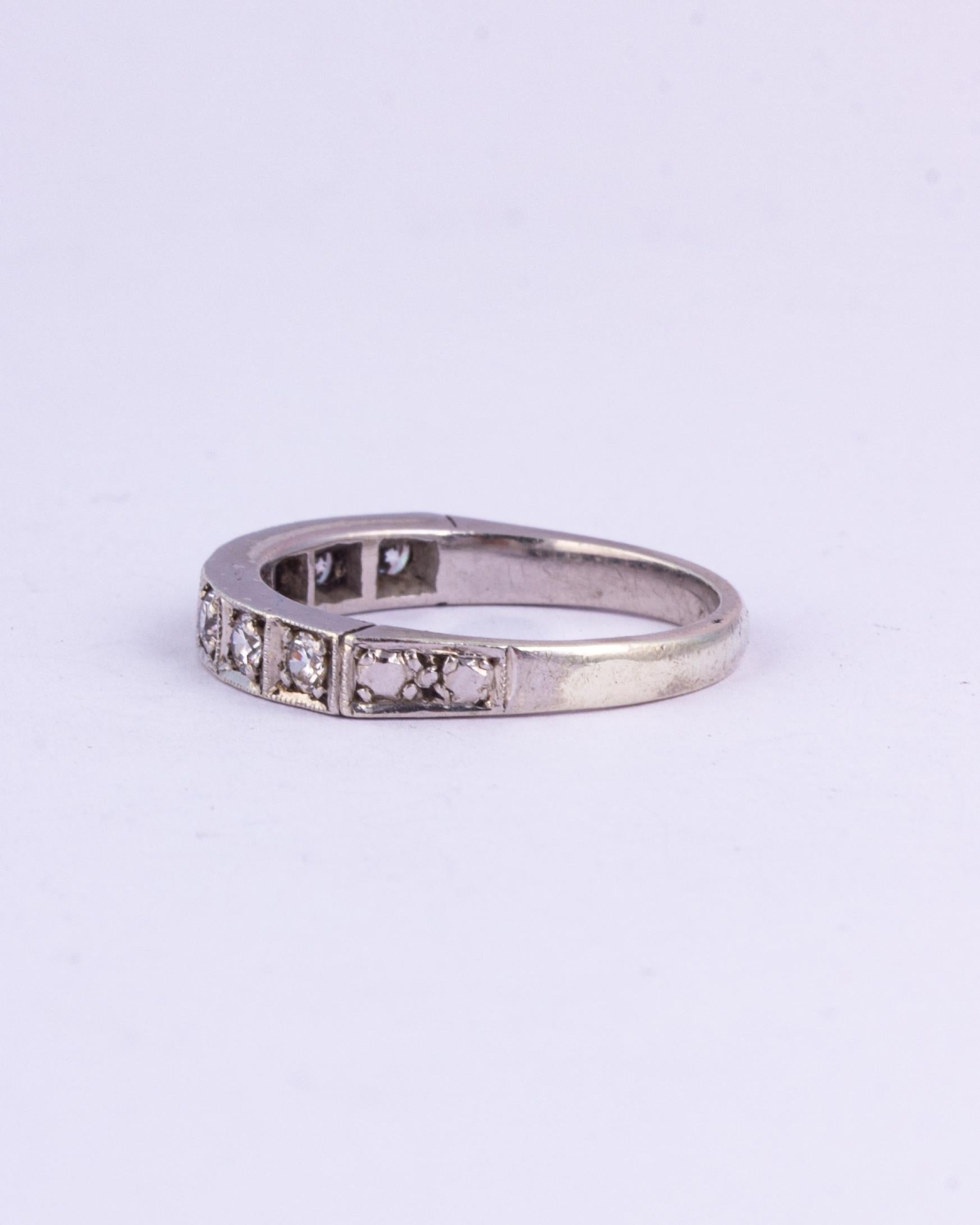 This half eternity band also has ornate shoulders that mimic the look of two diamonds. The diamonds in this band total approx 70pts and are bright and sparkly. Made in Birmingham, England. 

Ring Size: M 1/2 or 6 1/2 
Band Width: 3.5mm 

Weight: 3g 