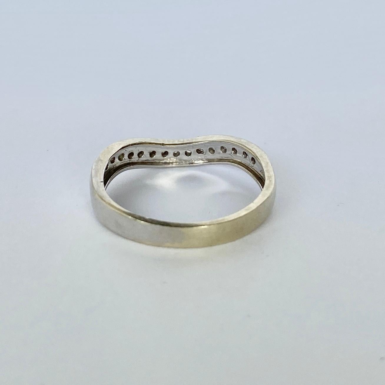 This half eternity band has a slight wave which is lovely worn alone or works well stacked with a solitaire ring. The diamonds in this band total approx 15pts and are bright and sparkly. 

Ring Size: L or 5 3/4 
Band Width: 3mm 

Weight: 1.8g 