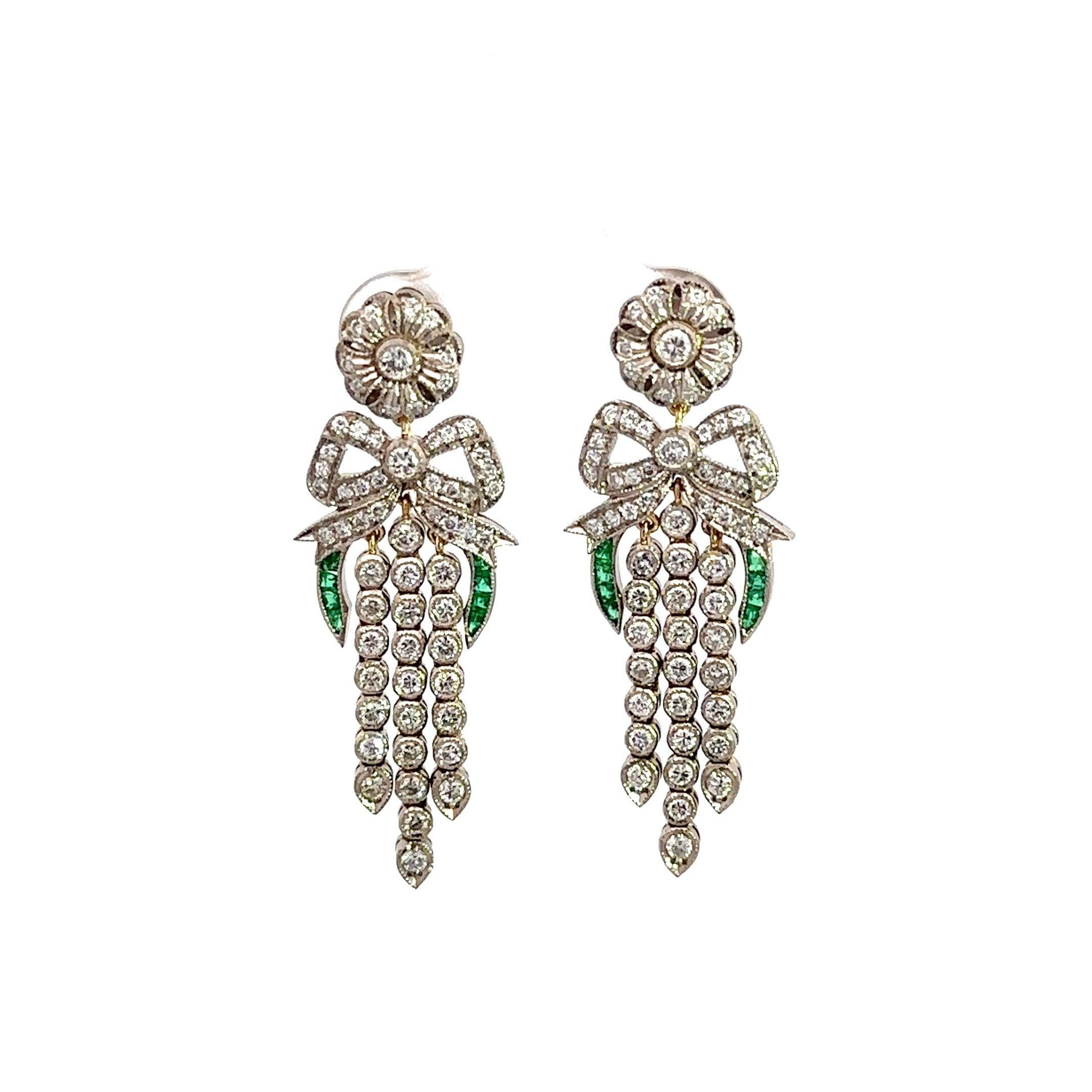 These vintage diamond chandelier earrings feature a bow and floral design motif and were crafted in the 1930's in 14KT white gold and 14KT yellow gold. The earrings feature approximately 2CT round diamonds , H-I Color, SI Clarity that adorn the