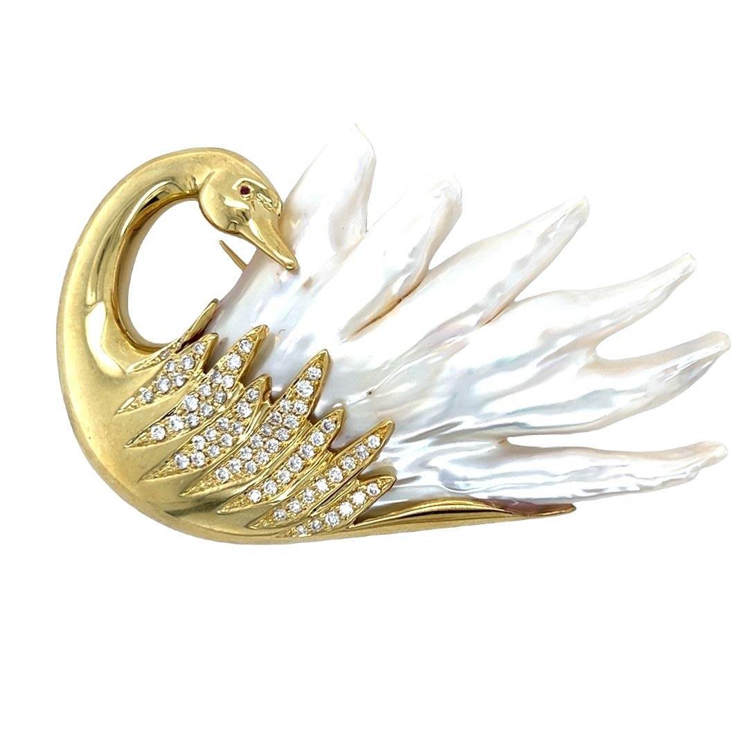 Vintage brooch pin featuring a beautiful 18-karat yellow gold swan with natural pearl feathers and a ruby eye. The brooch measures 7.5 cm x 5.5 cm. The 1.75 carats of round brilliant diamonds are white in color and eye clean. This statement piece is
