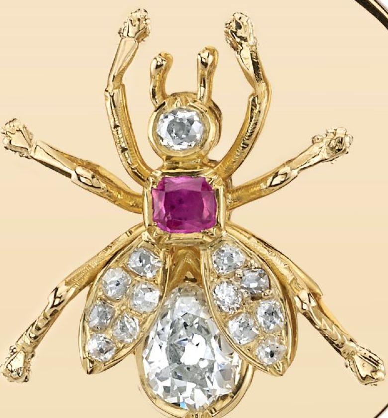 0.75ct I/VS Pear shaped diamond alongside 0.60ctw old Mine cut accent diamonds surrounding a 0.20ct vibrant pink sapphire. Vintage 18K yellow gold bee motif mounted on an 30mm 18K yellow gold disc. Bee motif dates circa 1910.

Our jewelry is made
