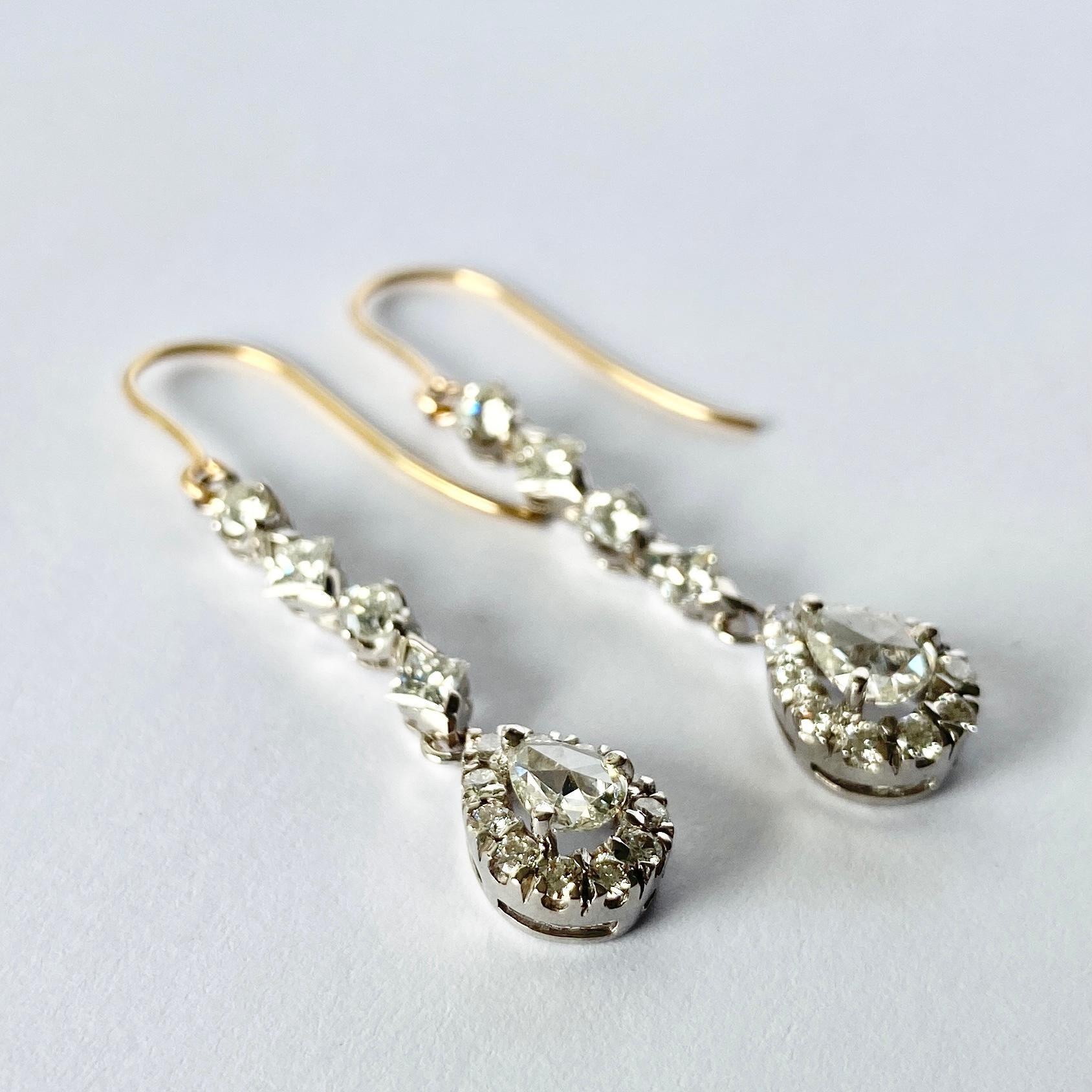 Both these stunning drop earrings boast a total of 1.2carats worth of diamonds per earring. The bottom of the drop holds a pear shaped diamond with diatoms surrounding it and these also hold princess cut diamonds. 

Drop Length: 41mm 

Weight: 4g