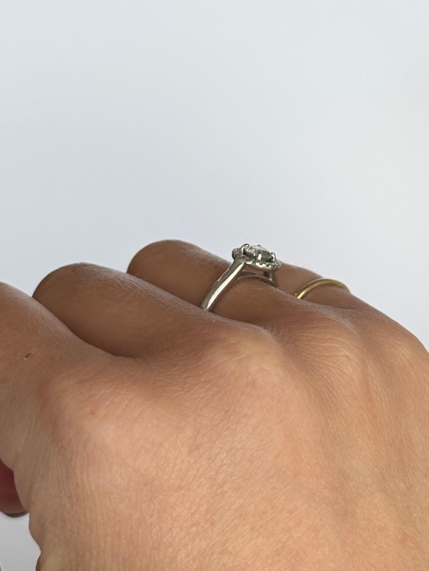 This gorgeous diamond ring holds a diamond at the centre of the halo measuring 50pts. The halo surrounding totals 19pts. This ring is modelled in platinum. 

Ring Size: J 1/2 or 5 
Cluster Diameter: 9mm
Height Off Finger: 5mm

Weight: 4.6g