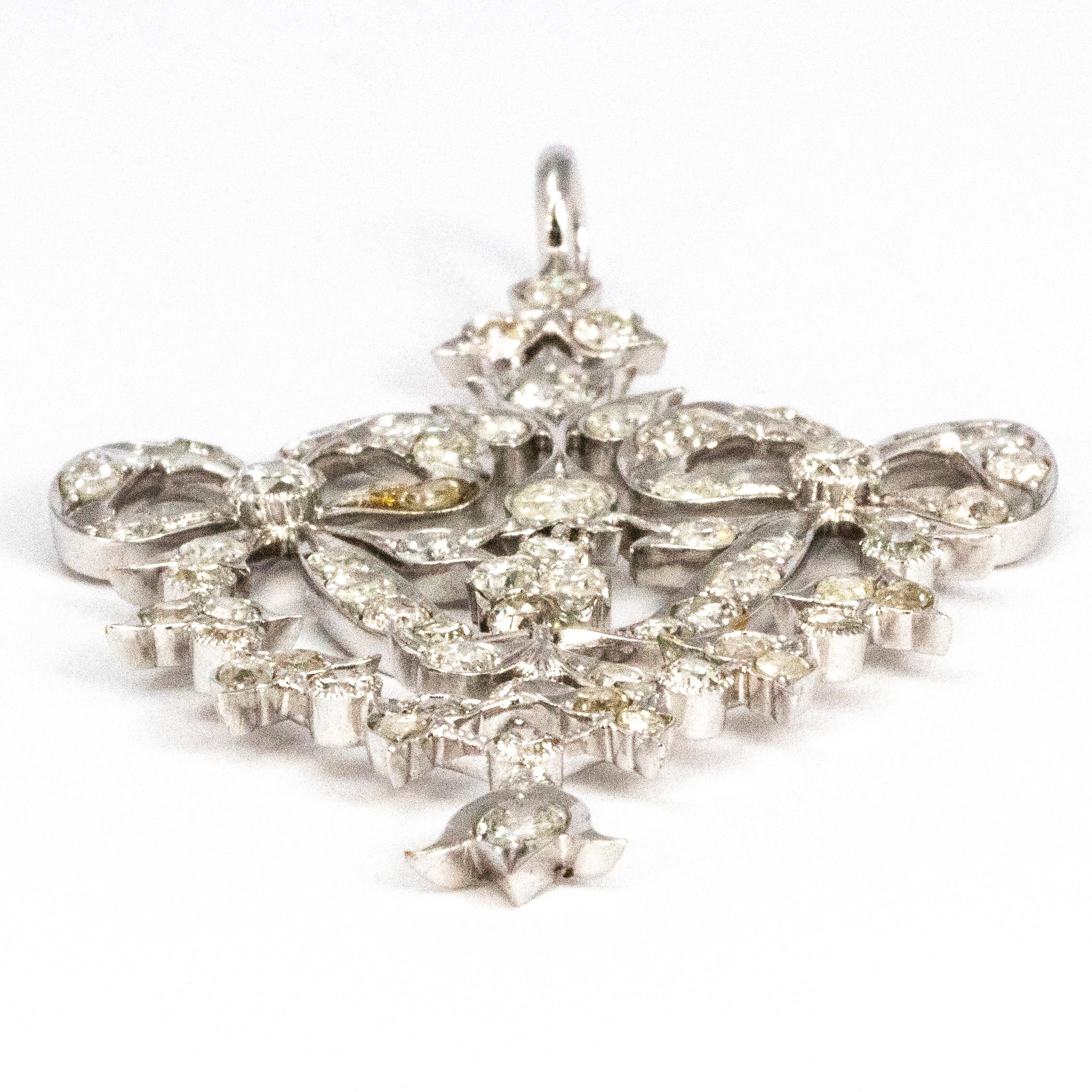 The shimmering diamonds glitter beautifully on this platinum pendant. The diamonds are old European cut. The design of this pendant features two bows with sweeping ribbons and has a few separate dangling stones throughout. 

Dimensions: 2 1/2 inch