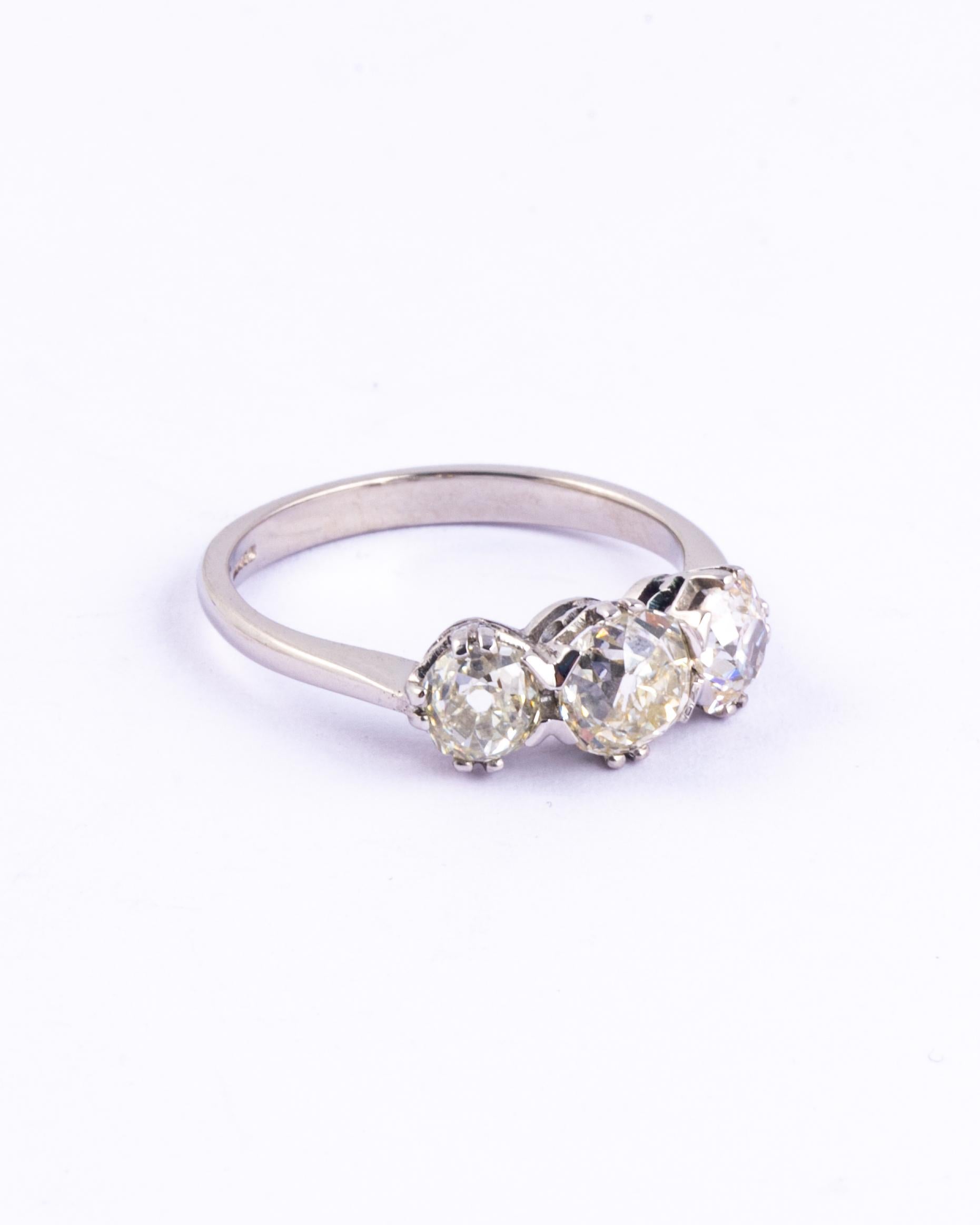 The three gorgeous diamonds in this ring are bright and have a wonderful sparkle. The central stone measures 1.11ct, and the two outer stones measure 60pts and 65pts. All diamonds are H colour VS2 and old mine cut. Set in simple claw settings this