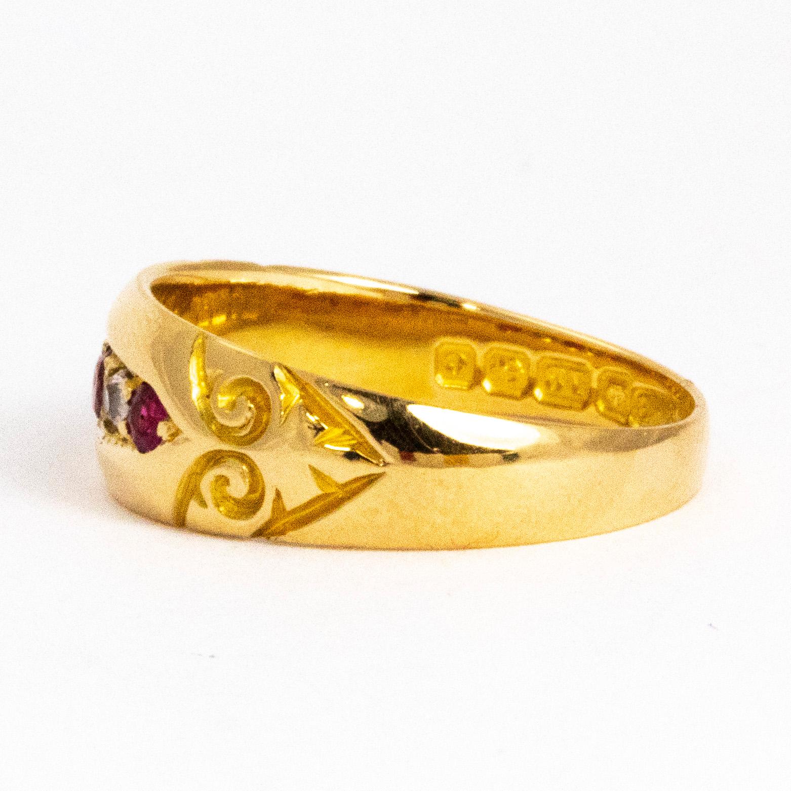 This 18ct gold band is packed with detail! The ring holds three deep pink rubies and two sparkling diamonds. The rubies total 17pts and the diamonds total 10pts. They are set flush in a boat shaped setting with scroll engraved detail either end. The