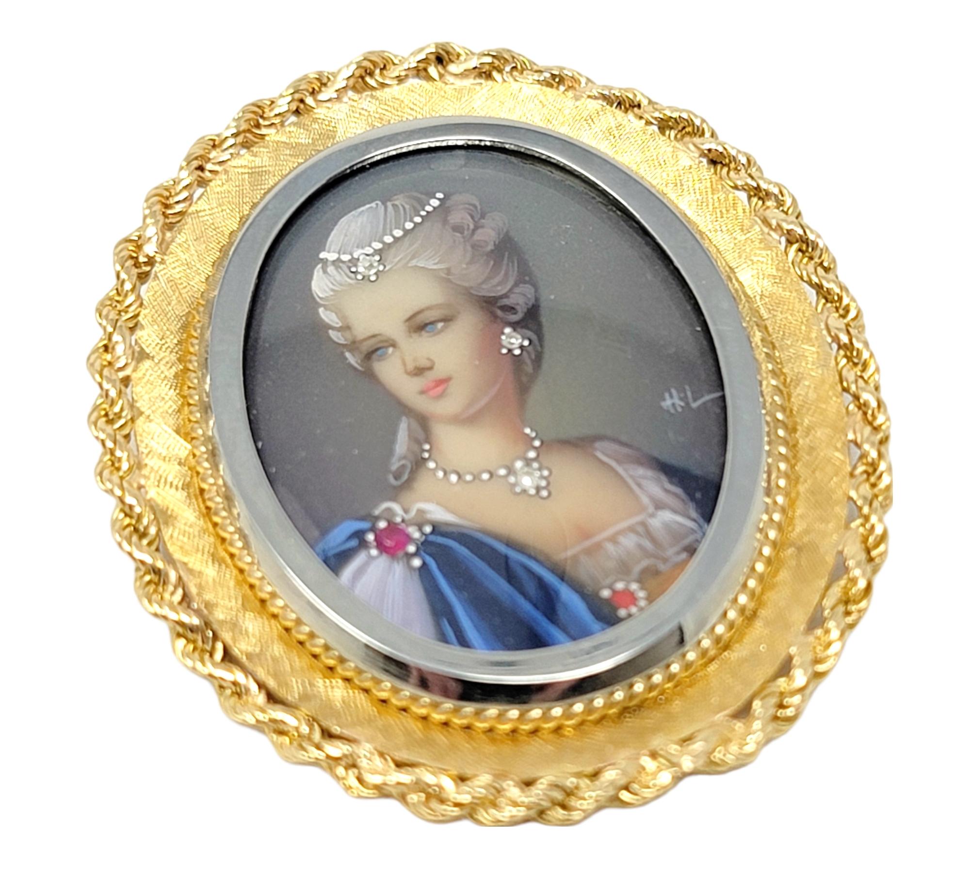 Lovely, one of a kind vintage brooch / pendant with delicate diamond and ruby accents. It features a stunningly detailed portrait of a woman adorned in jewels with a luxurious gold oval frame.  

Metal: 18K Yellow Gold
Weight: 13.48 grams 
Natural
