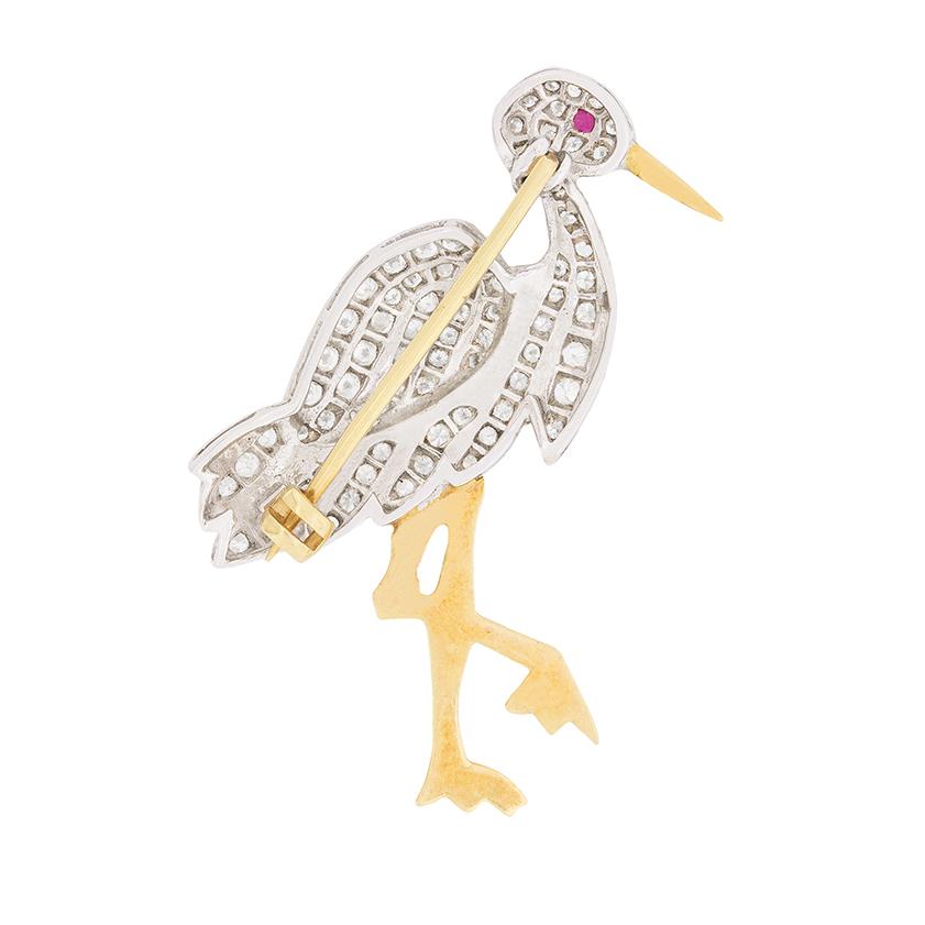 Dating to the 1950s, there is a total of 1.40 carats of diamonds on this brooch. It has been shaped into a stork and grain set with the diamonds which are estimated as F-G in colour and VS-SI in clarity. Their is a small ruby for the eye which is a