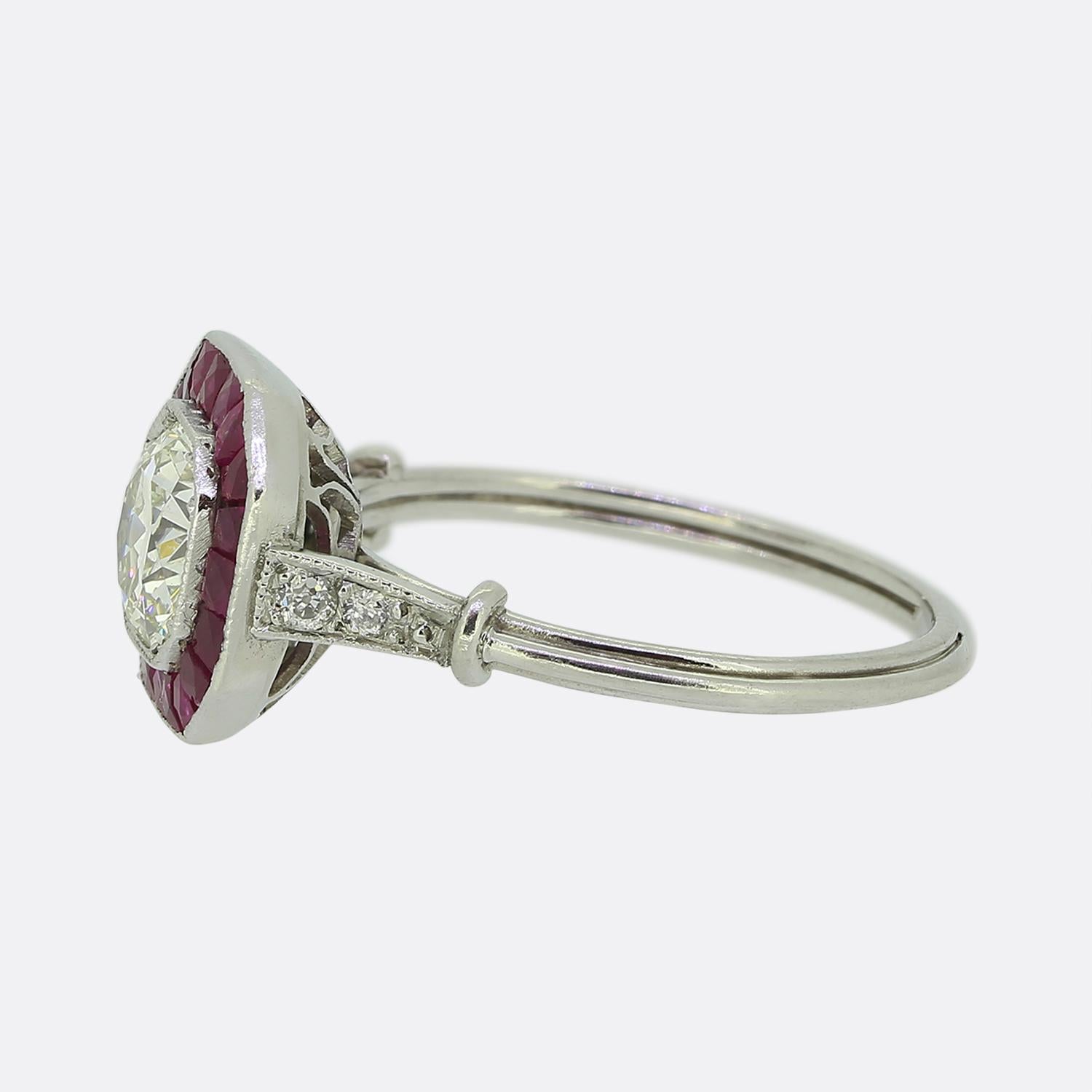 Here we have a truly wonderful diamond and ruby target ring. This vintage ring has been handcrafted in platinum and features a central old European cut diamond of Approximately 0.80 carats. The surrounding rubies have been calibre cut to fit this