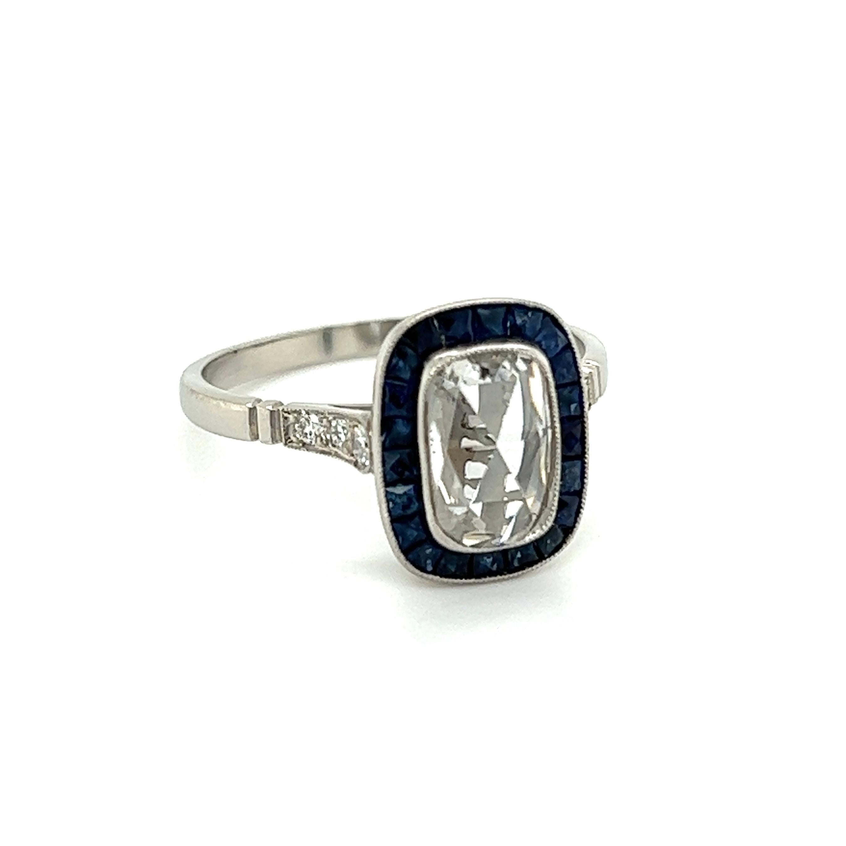 Simply Beautiful! Finely detailed Art Deco Revival Diamond and Sapphire Cocktail Ring. Centering a securely nestled Hand set 0.70 Carat 8mm Rose Cut Diamond, surrounded by Sapphires, approx. 1.00tcw and 6 Diamonds, approx. 0.10tcw on shank. Approx.