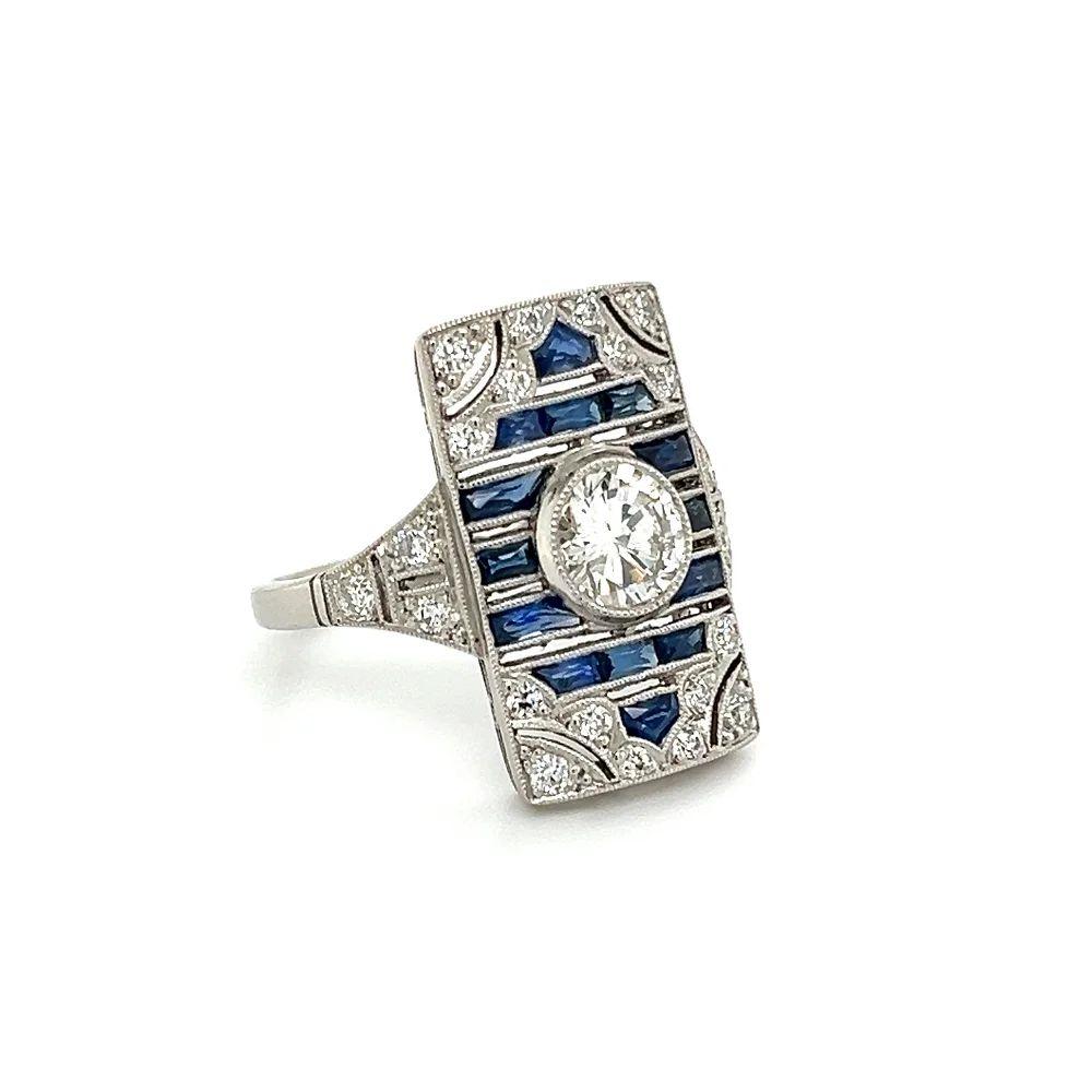 Simply Beautiful! Elegant and finely detailed Vintage Diamond and Sapphire Art Deco Revival Platinum Cocktail Ring. Centering a securely nestled Hand set 0.83 Carat Transitional Diamond. Surrounded by 16 Custom cut Sapphires, weighing approx.