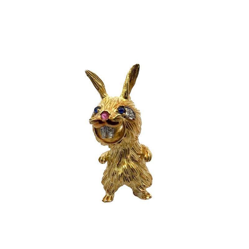 This charming vintage rabbit brooch is crafted from 18k gold and accented with sparkling diamonds and sapphire eyes, adding a playful touch. Measuring 1-7/8 x 3/4 inches and weighing 21.16 grams, this finely detailed brooch showcases craftsmanship