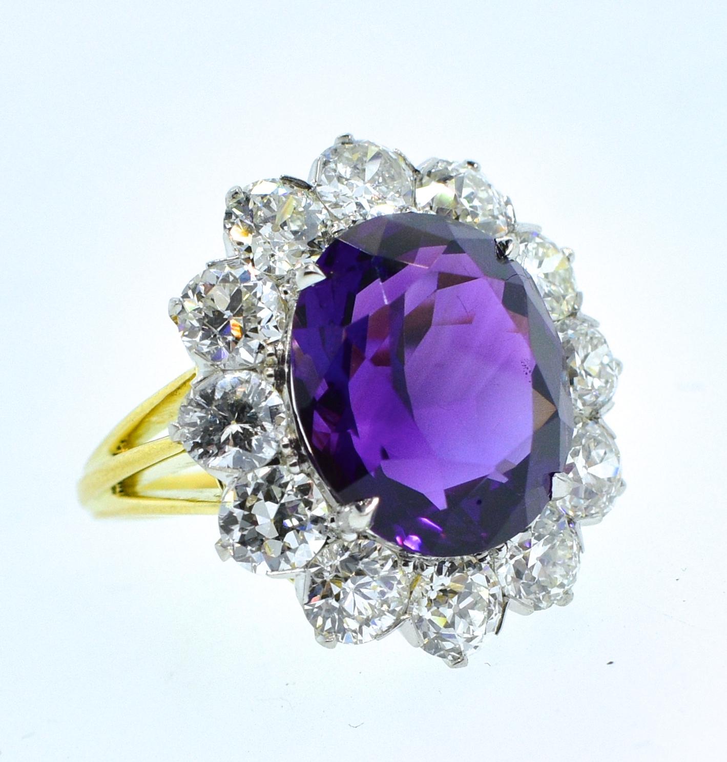 Antique diamond ring centering a fine vivid deep purple natural amethyst (probably from Siberia)weighing 7 cts. and surrounded by fine white old cut diamonds.  The diamonds are well cut and well match, near colorless, (H) and very slightly included