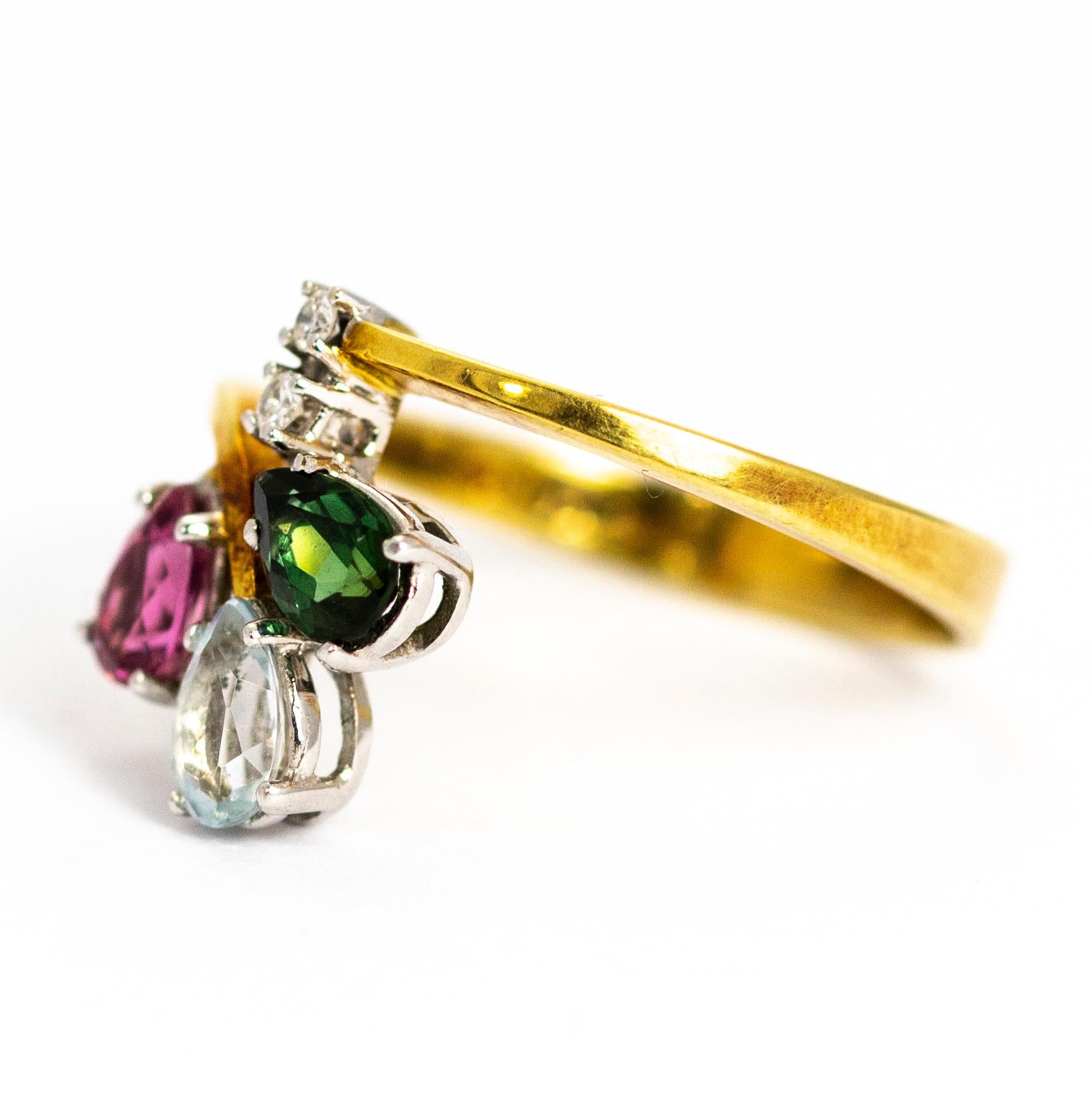 This wonderful ring holds two small diamonds sat at the base of a fan shaped cluster of pear cut tourmaline stones. These stones are green, pale blue and pink all set in platinum. The diamonds measure approximately 5pts and the Tourmaline measure