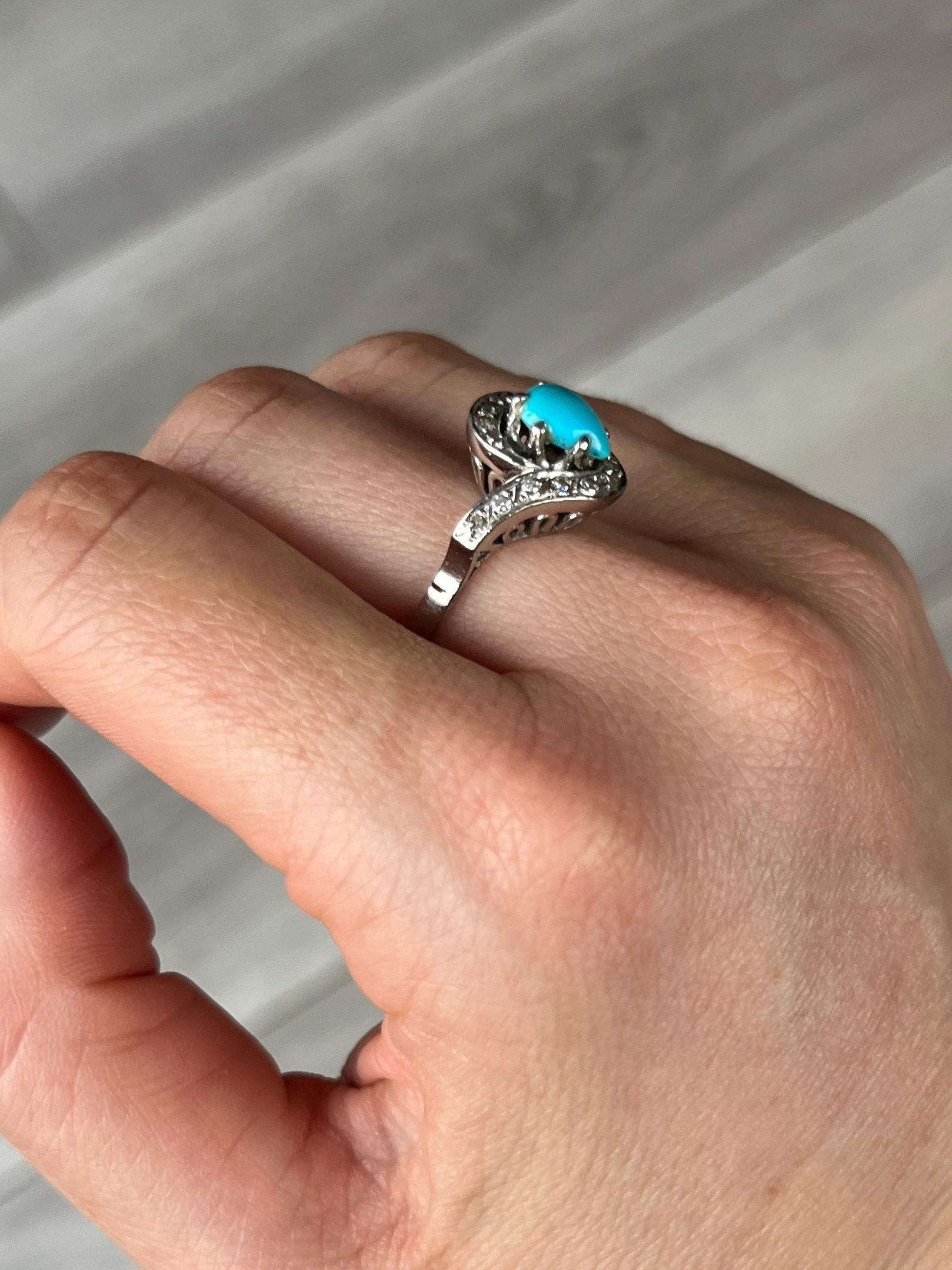 The swirl design of this ring suits the shape of the turquoise stone perfectly. The ring is modelled in platinum and also holds diamonds that surround the blue stone. The diamond total of this ring is 34pts.

Ring Size: P or 7 3/4 
Cluster Diamater: